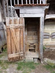 Run down, worn wood Russian outhouse