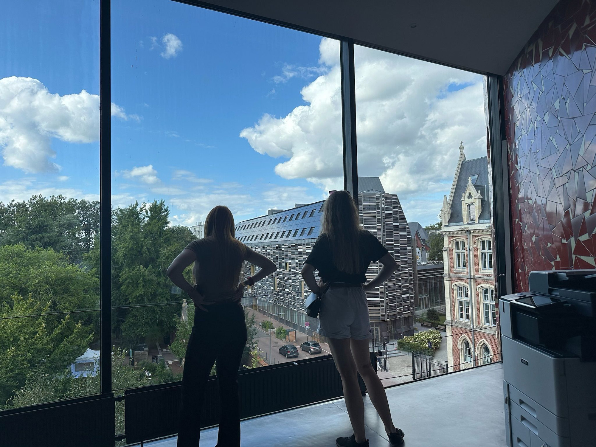 Two figures standing at a large window a Lille Catholic University, the conference venue