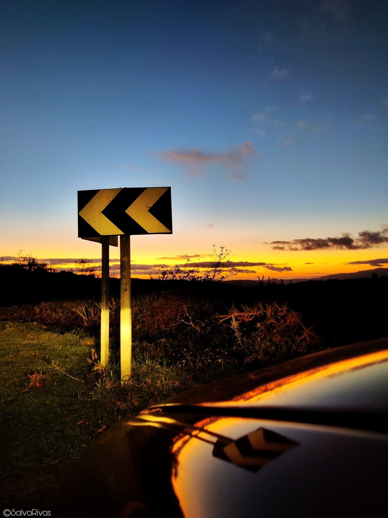 The road disappears into the horizon, just like the setting sun. 
In this autumn sunset, the calm surrounds us like a warm blanket 🍂🌄🍂.