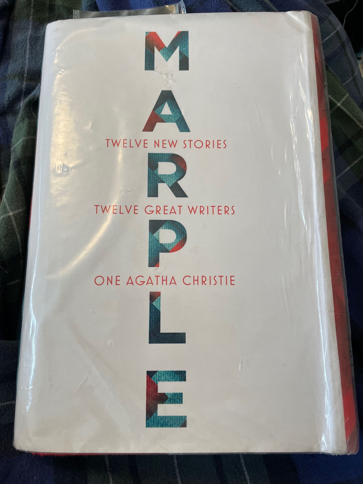 A library hardcover copy of Marple, with the text on the front cover reading: Twelve new stories, twelve great writers, one Agatha Christie