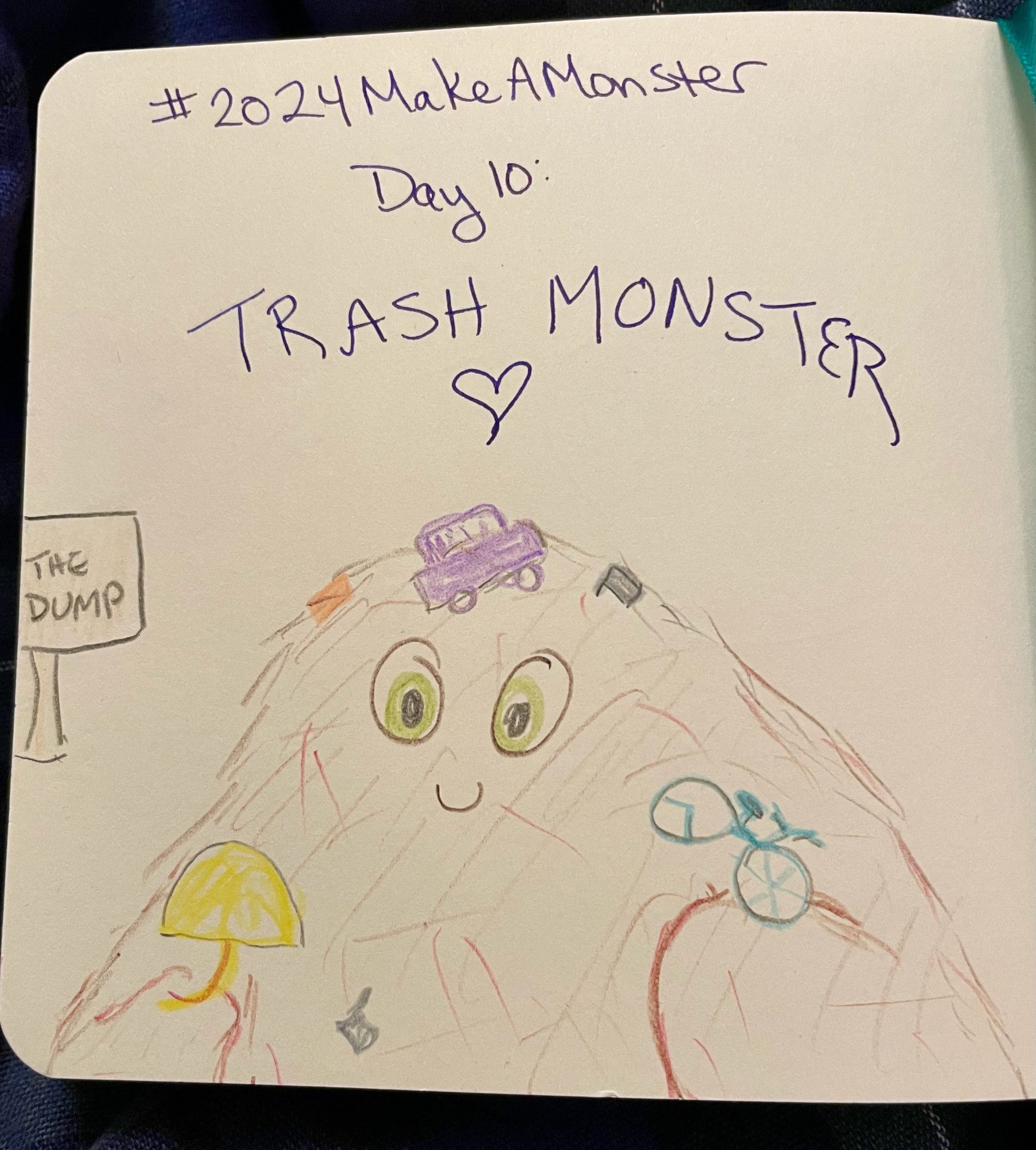 On a small, square sketchpad, a sign points to The Dump - which is actually animate, a massive, beaming monster covered by discarded trash and holding some of her favorites (an unmbrella and a bicycle) in her big paws. Above the picture, the text reads #2024MakeAMonster Day 10: Trash Monster