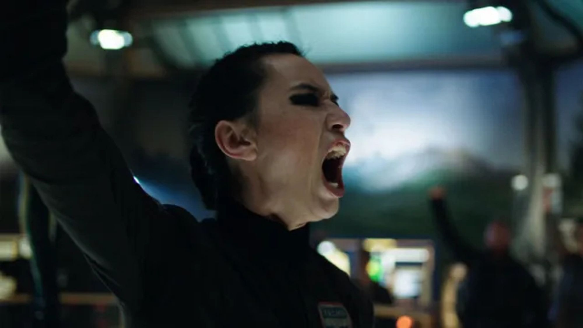 Cara Gee as Camina Drummer in The Expanse.

Raising her arm chanting "Beltalowda!".