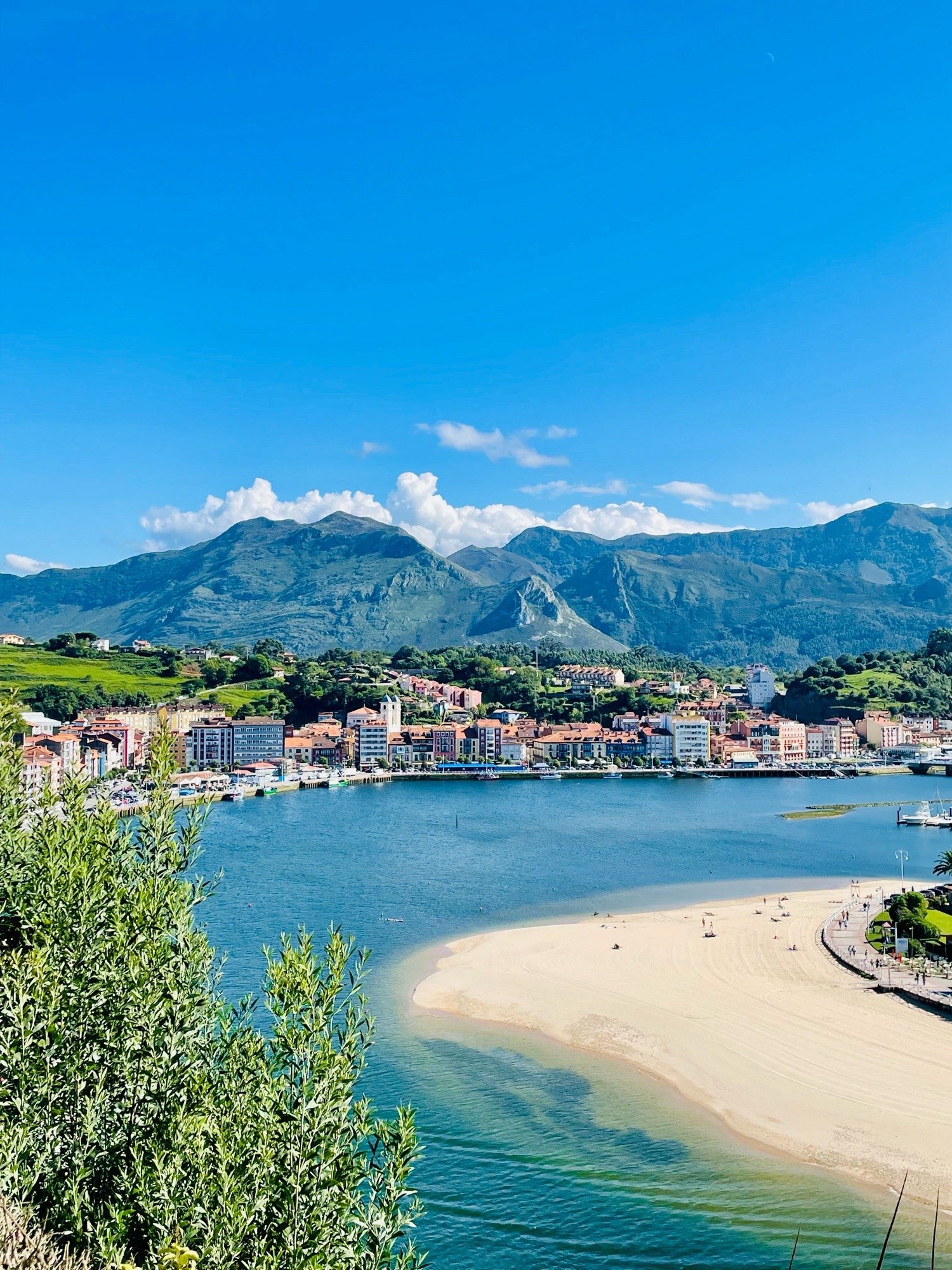 Ribadesella, River Sella, the Beach against the mountains backdrop on a clear sunny day.