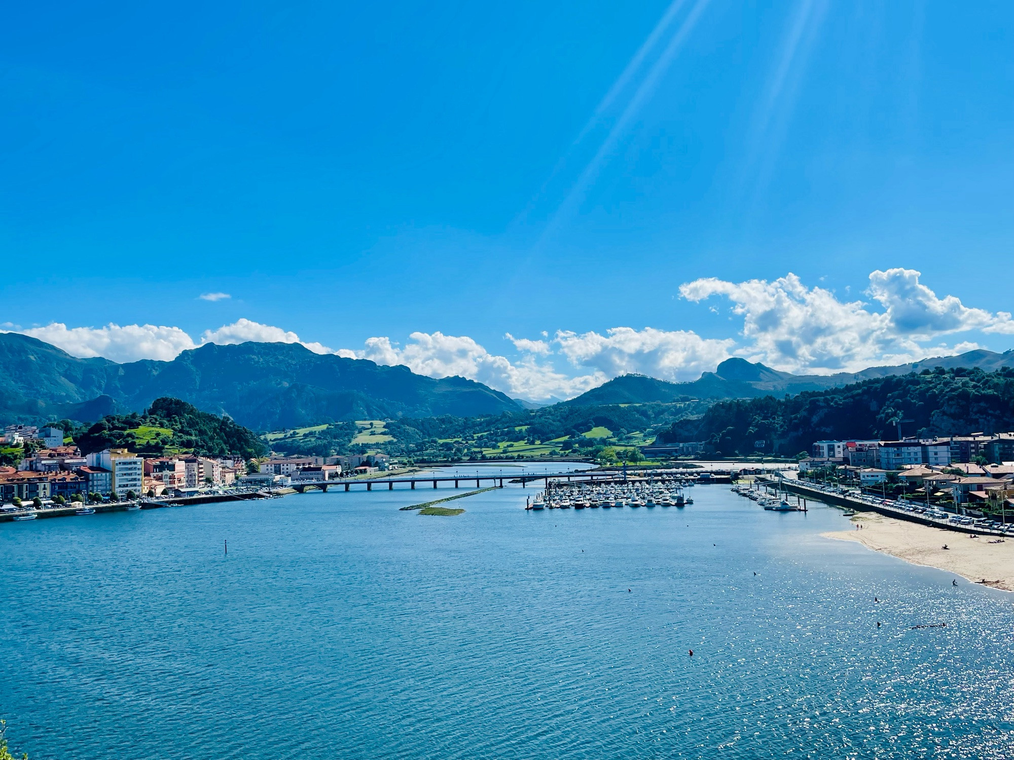 Ribadesella, River Sella, the Beach against the mountains backdrop on a clear sunny day.