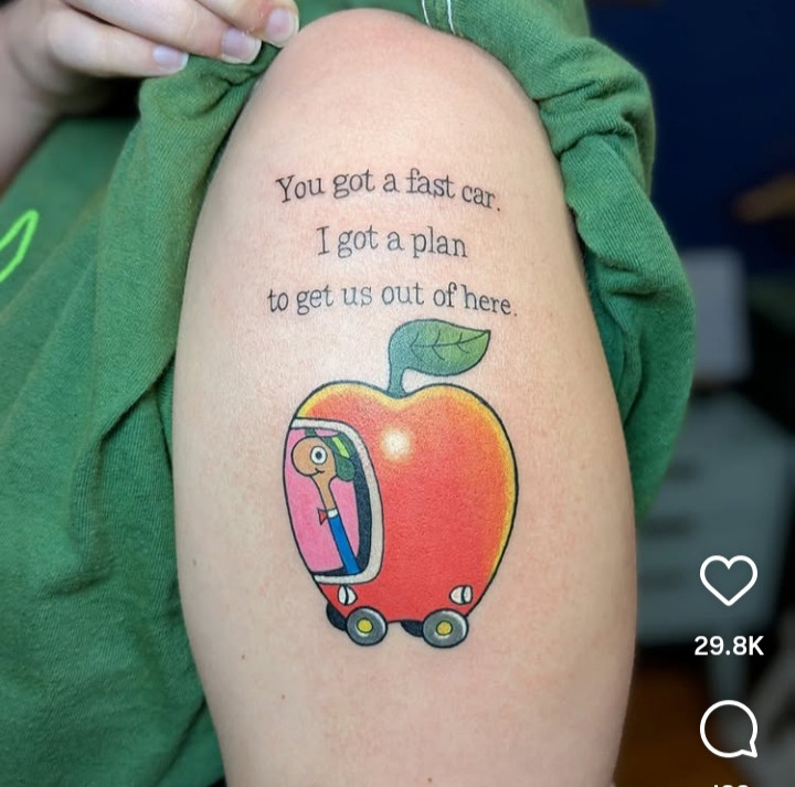 A tattooed knee, I think, featuring Richard Scarry's Lowly Worm in an apple car. Text reads: You got a fast car. I got a plan to get us out of here.