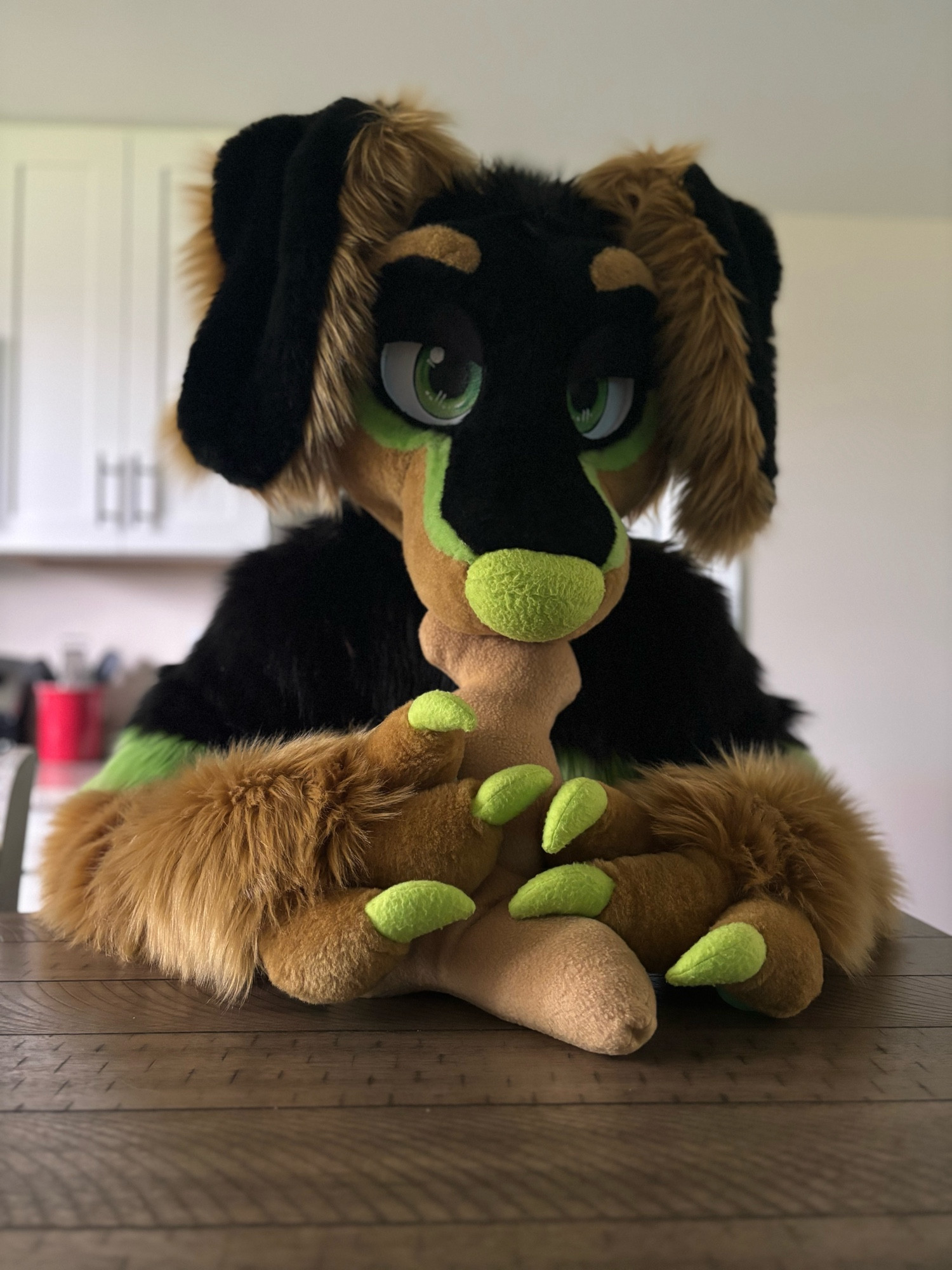 dachshund fursuiter chowing down on a dino nugget plush