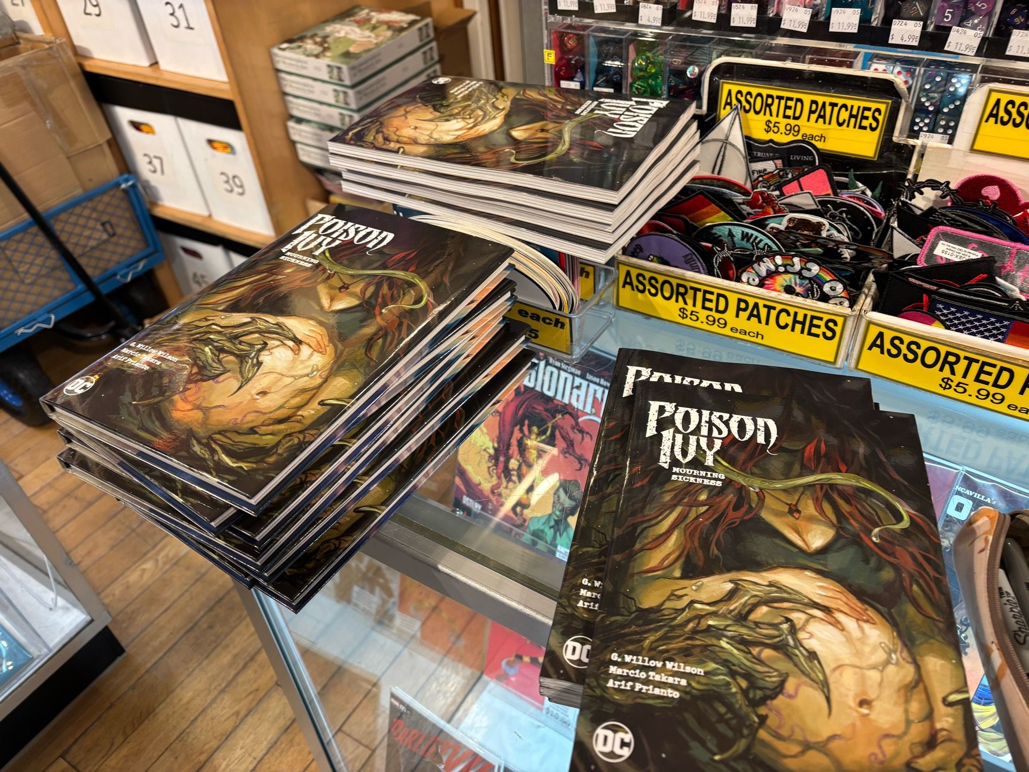 A stack of poison ivy books on a glass countertop