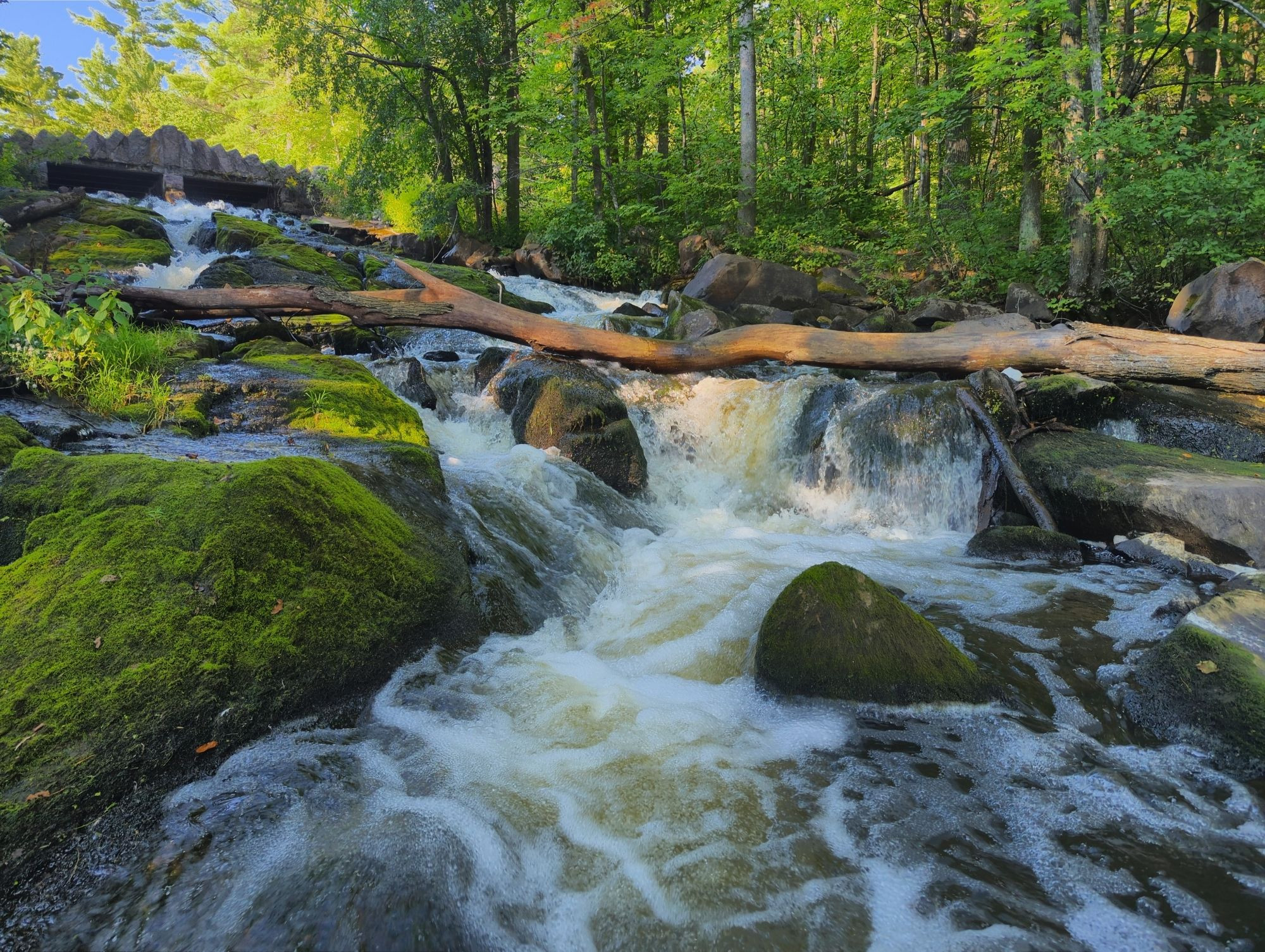 Water flowing down from a small stone bridge