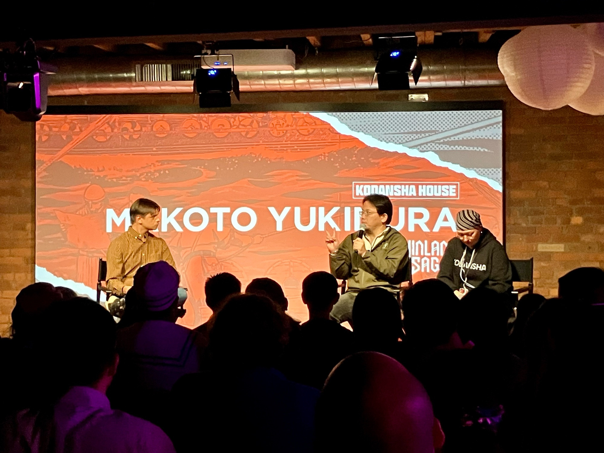 Manga artist Makoto Yukimura on speaking on stage with interpreter and moderator.