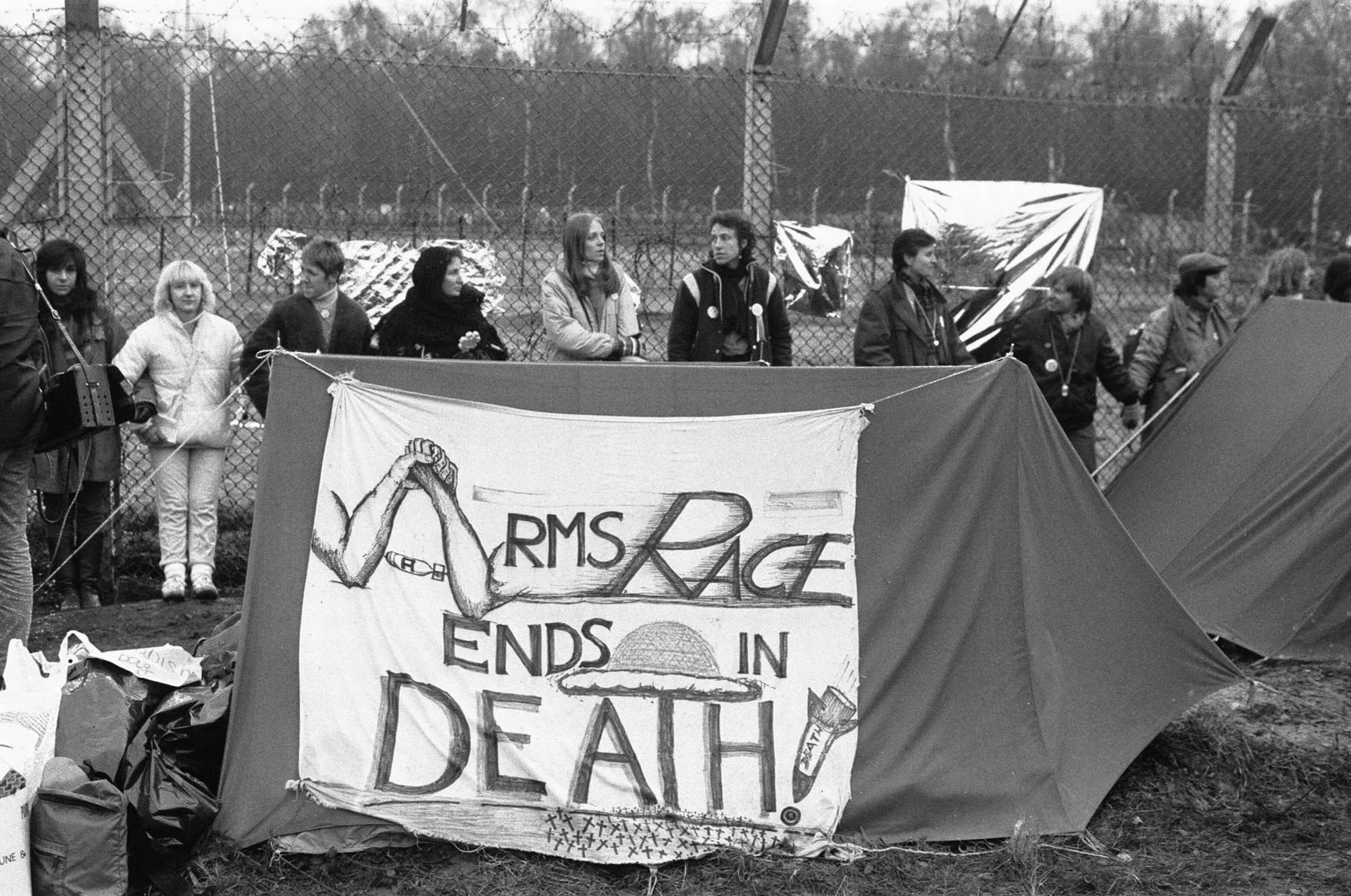 The signs put together by the protesters were excellent in getting their message across. Photo and caption from Berkshire Live.

https://www.getreading.co.uk/news/berkshire-history/gallery/powerful-1983-greenham-common-protest-22193828