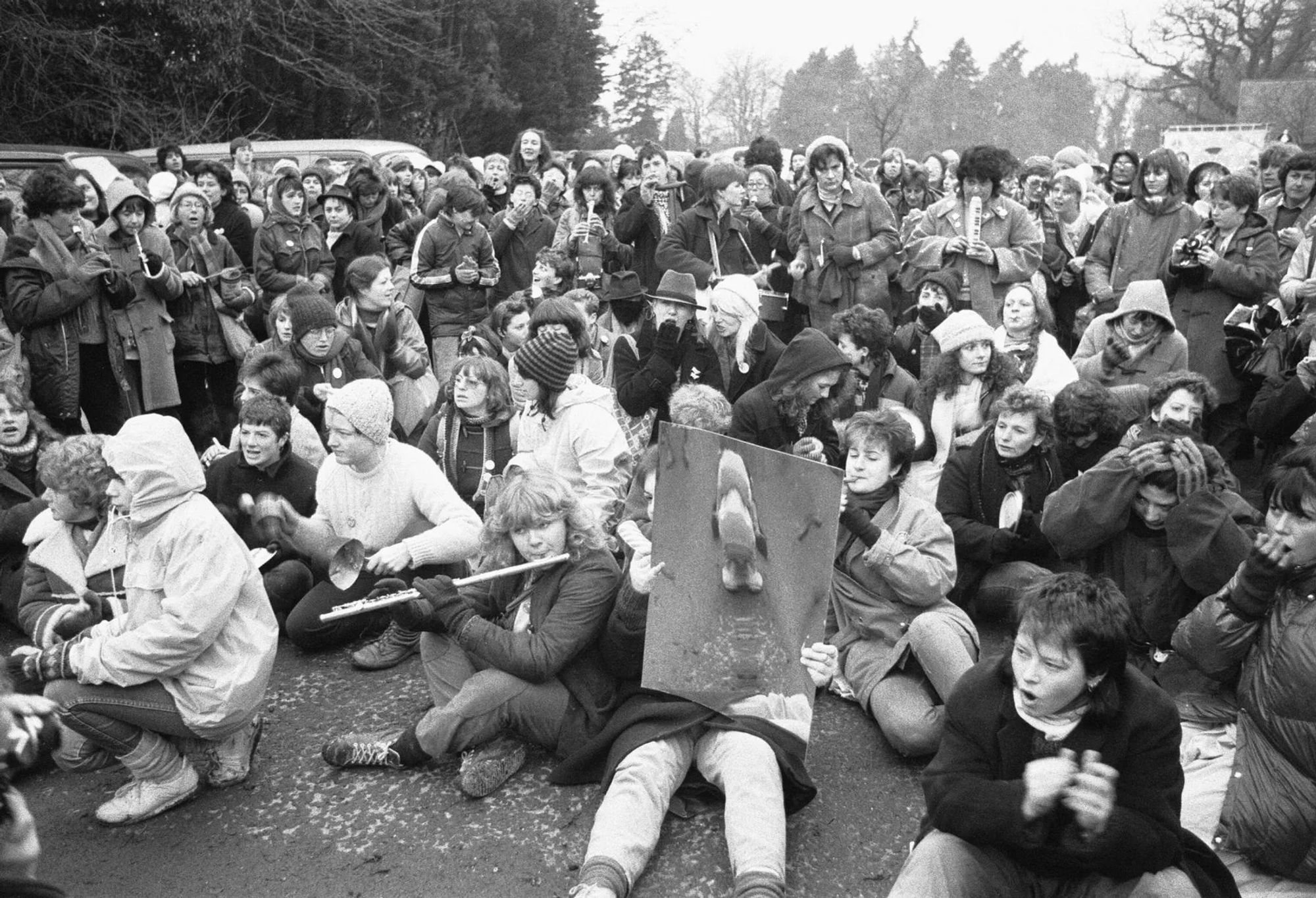 Women began a sit down protest on the road leading to the airbase gates. Photo and caption from Berkshire Live.

https://www.getreading.co.uk/news/berkshire-history/gallery/powerful-1983-greenham-common-protest-22193828