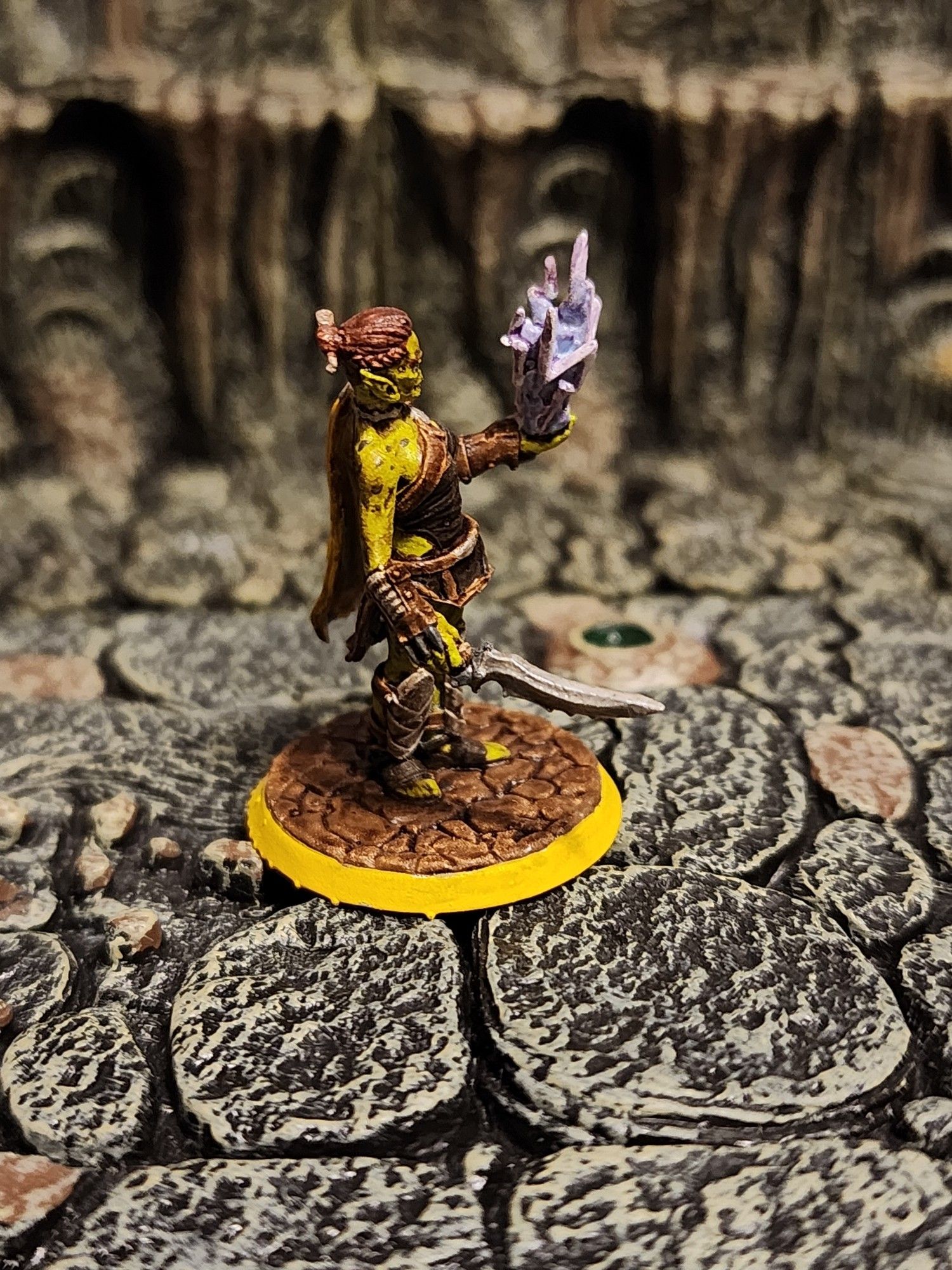 A sideview of the Githyanki woman, better showing her long dagger, the details of her bracers, and the magical lightning she is conjuring. Also visible are the braids and bun used to hold her hair back.