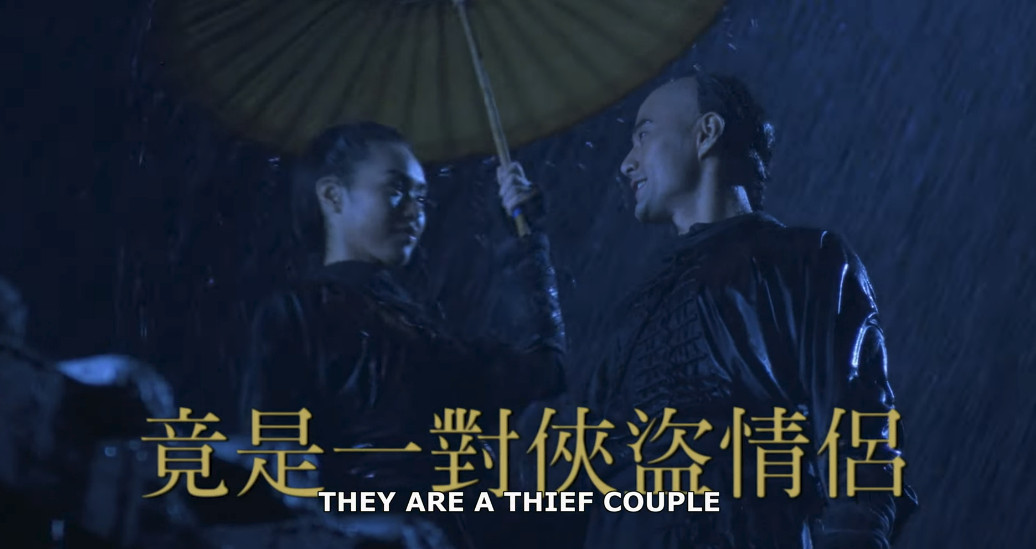 Jean Wang and Rongguang Yu smile at each other on a rainy night while wearing thief garb in the trailer for Iron Monkey (1993).
[CAPTION: THEY ARE A THIEF COUPLE]