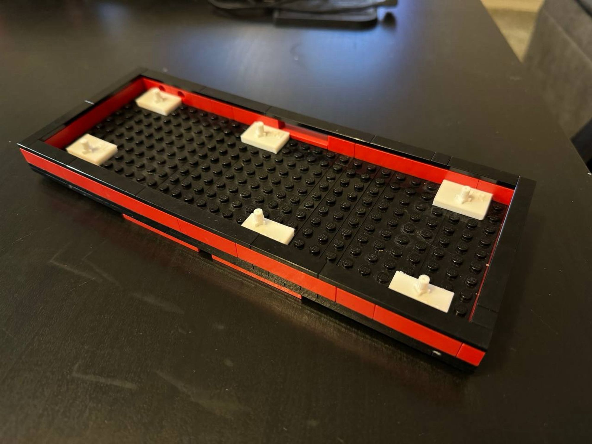 Lego keyboard chassis with 3D printed standoffs that match the keyboard PCB mounting points.