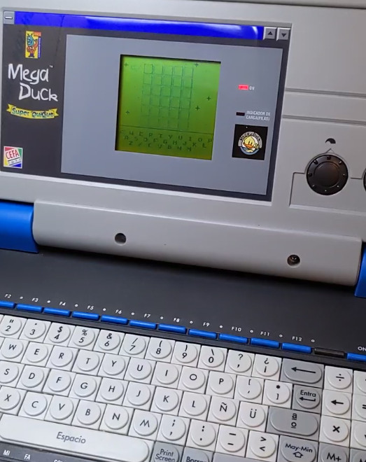 Picture of MegaDuck laptop with keyboard and showing wordle on the screen