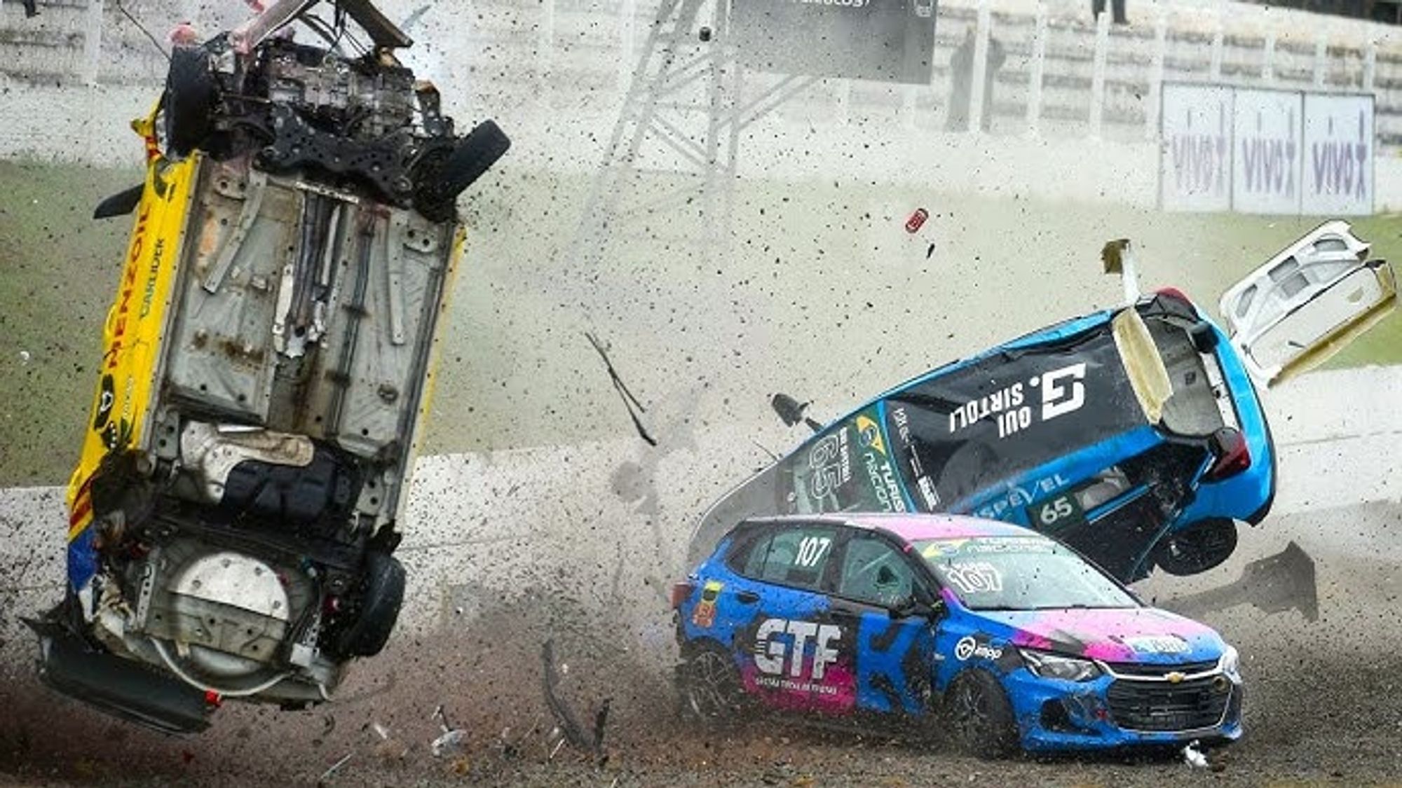 Photo of 3 stock cars in a collision, flipping through the air.