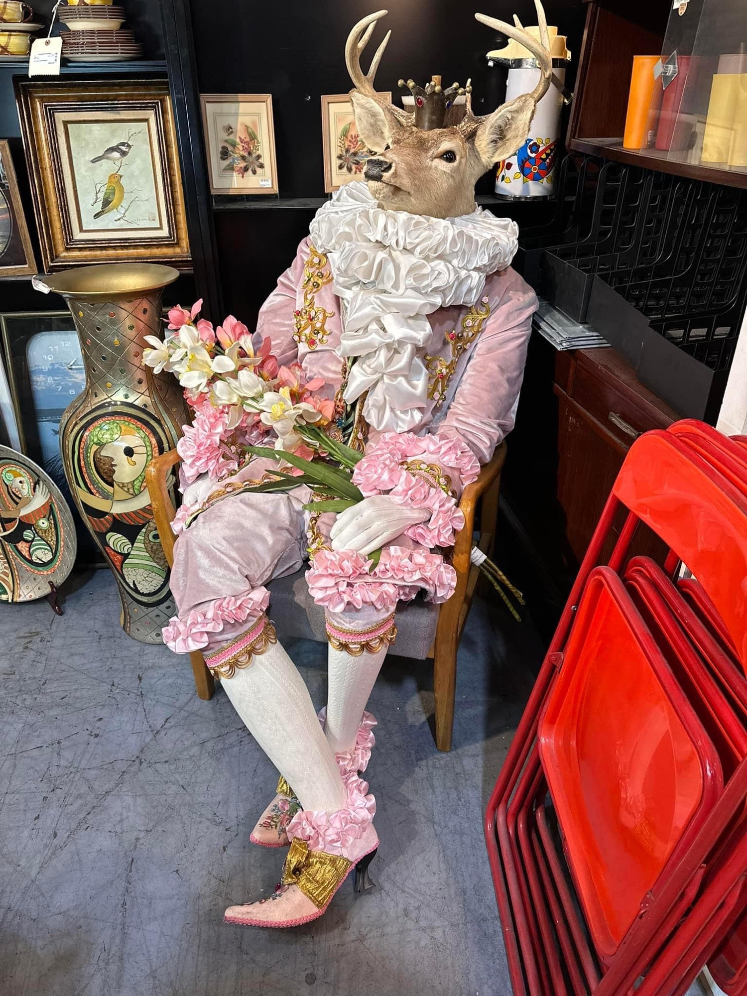 taxidermy deer head attached to a mannequin in a men’s pink rococo style outfit