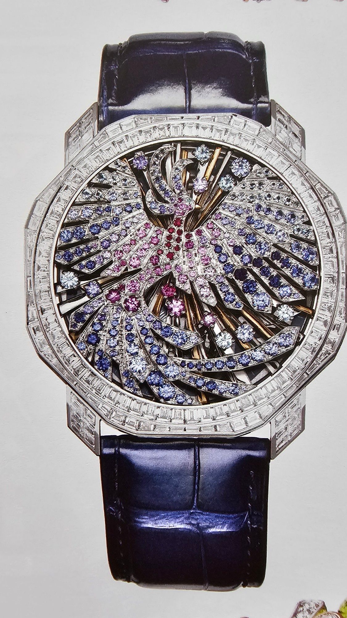 Gem encrusted Phoenix watch, looks hard as hell to read but it's more jewelry than watch. Your servant can tell you the time.