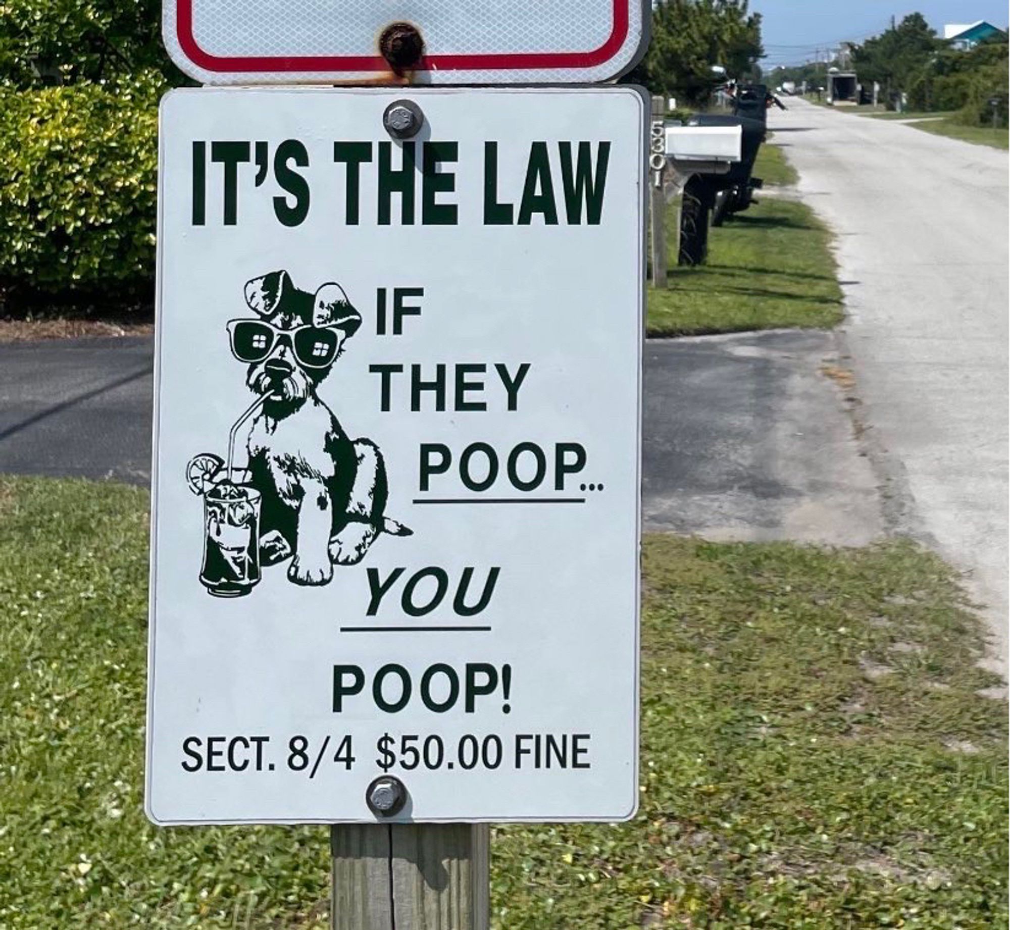 Road sign reads: it’s the law. If they poop, you poop.