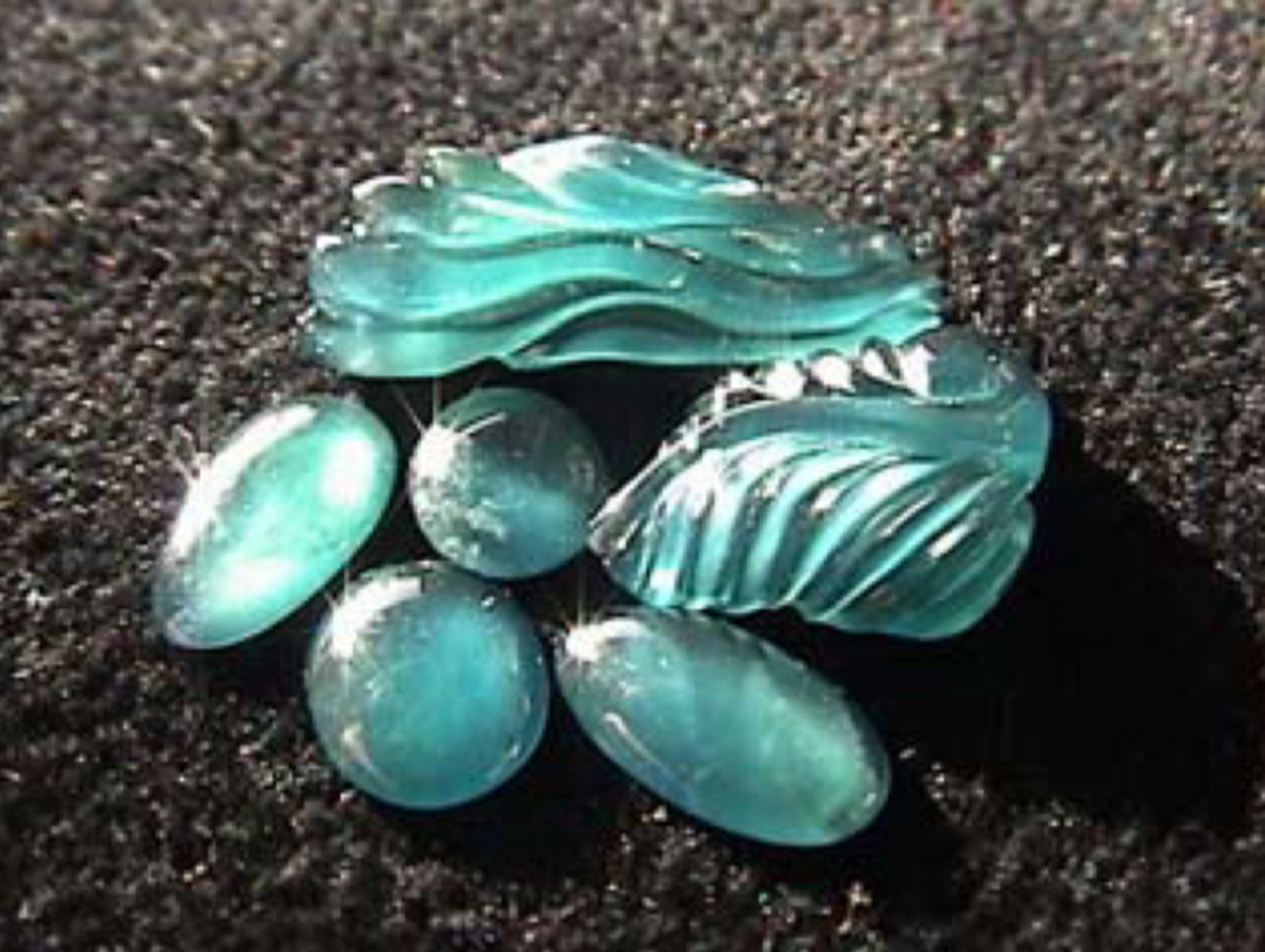 Aqua-blue carvings of blue omphacite from Guatemala. Image from http://research.amnh.org/users/gharlow/BlueJade0316b.pdf