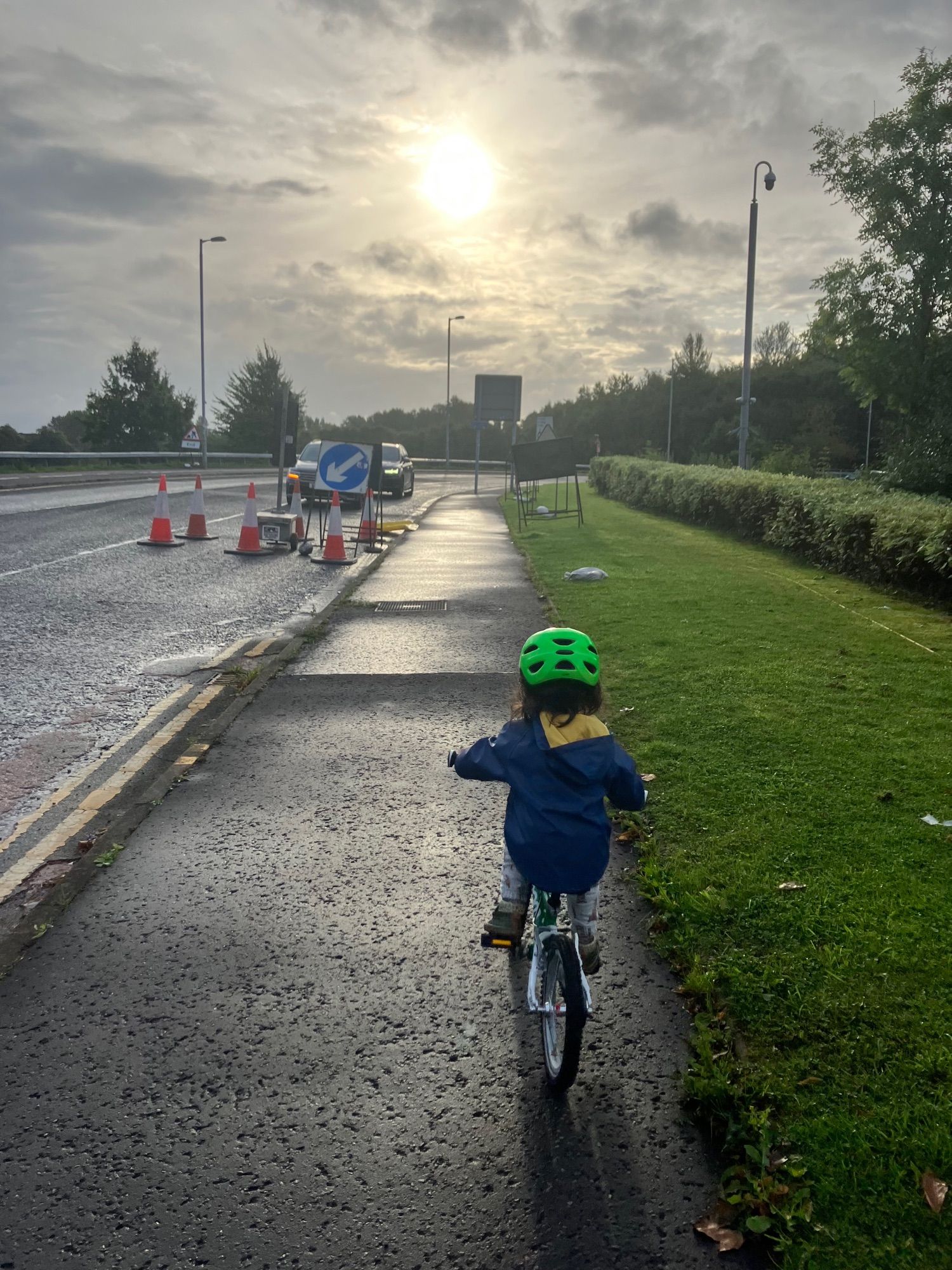 Child cycling in morning sun