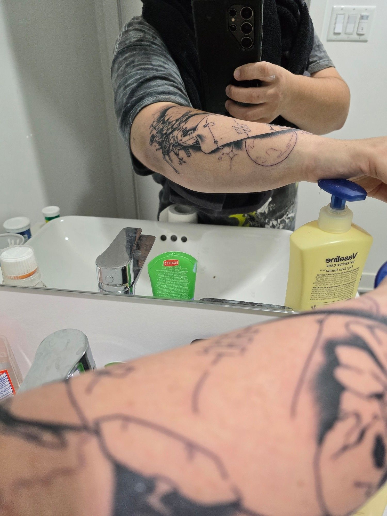 Picture of a fresh tattoo in  fromt of the mirror