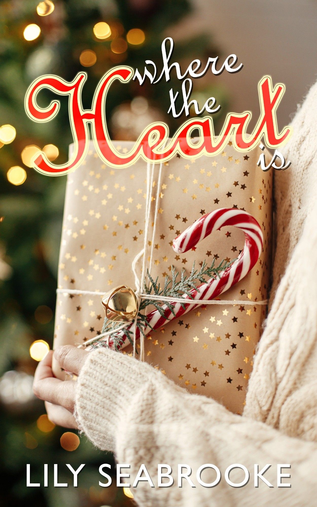 A book cover for Where the Heart Is by Lily Seabrooke, showing a woman holding a package wrapped for Christmas