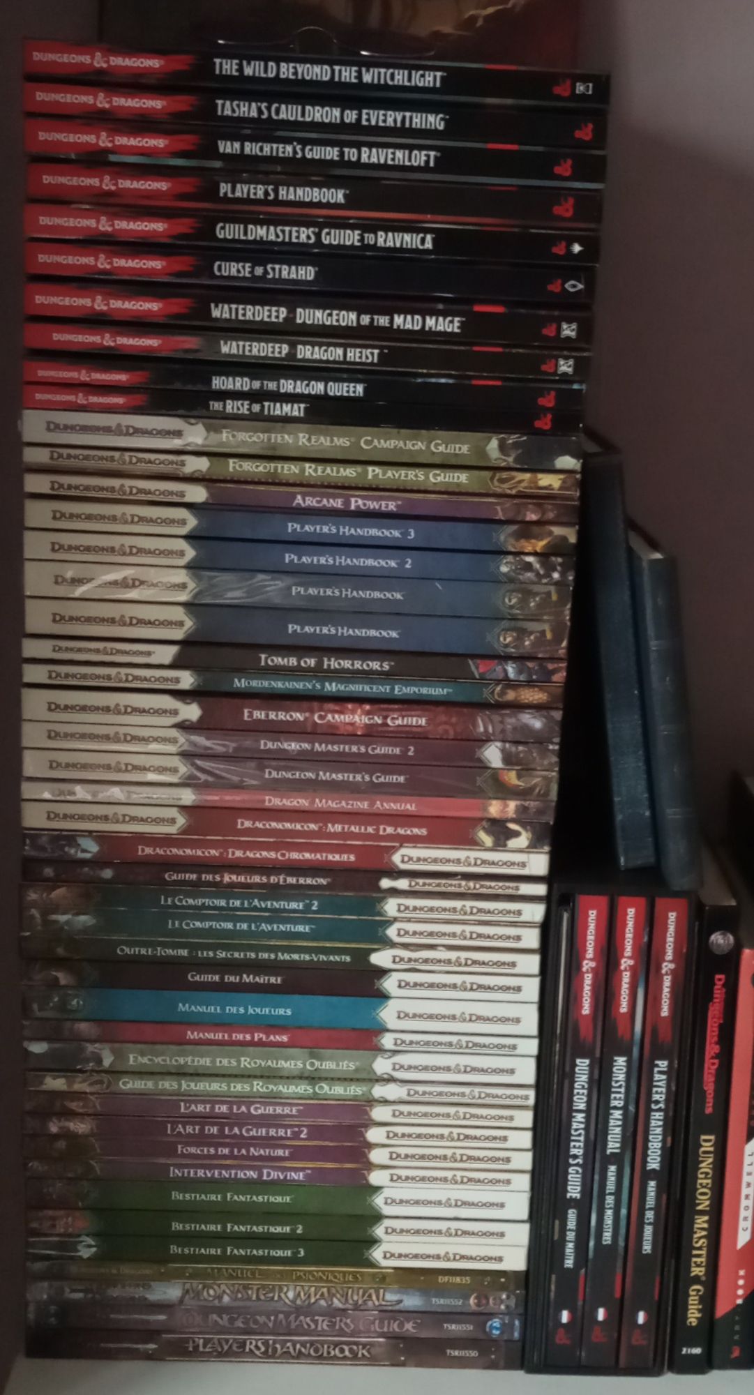 A pile of 49 D&D handbooks, manuals and guides from 1st, 3rd, 3.5rd, 4th and 5th editions.