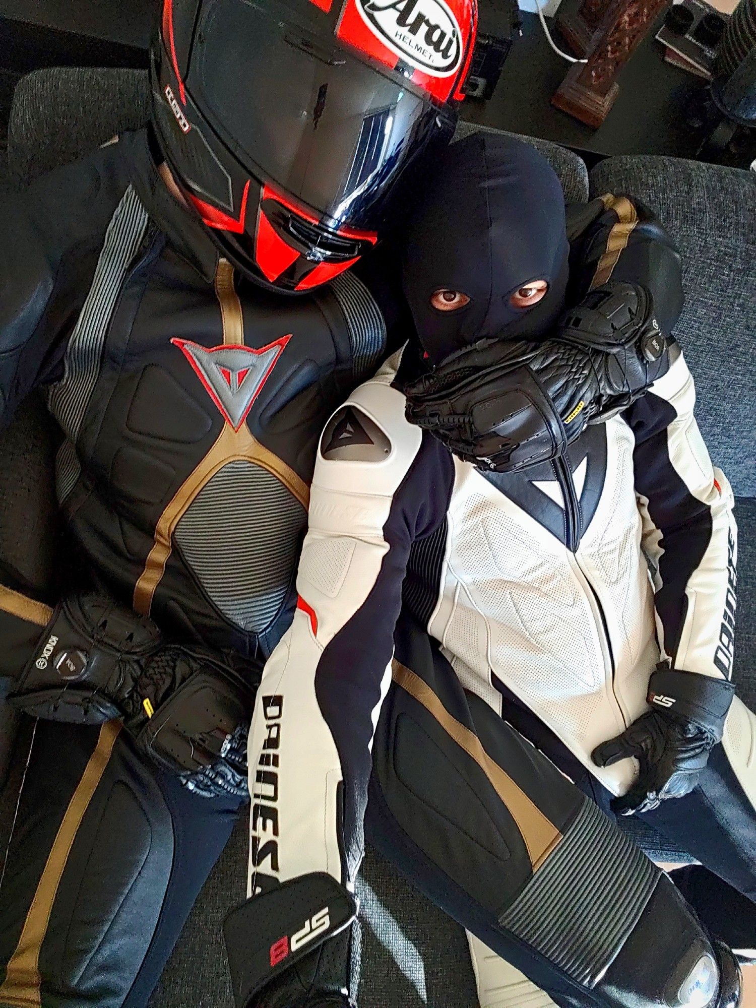 Two leather bikers sitting on the couch