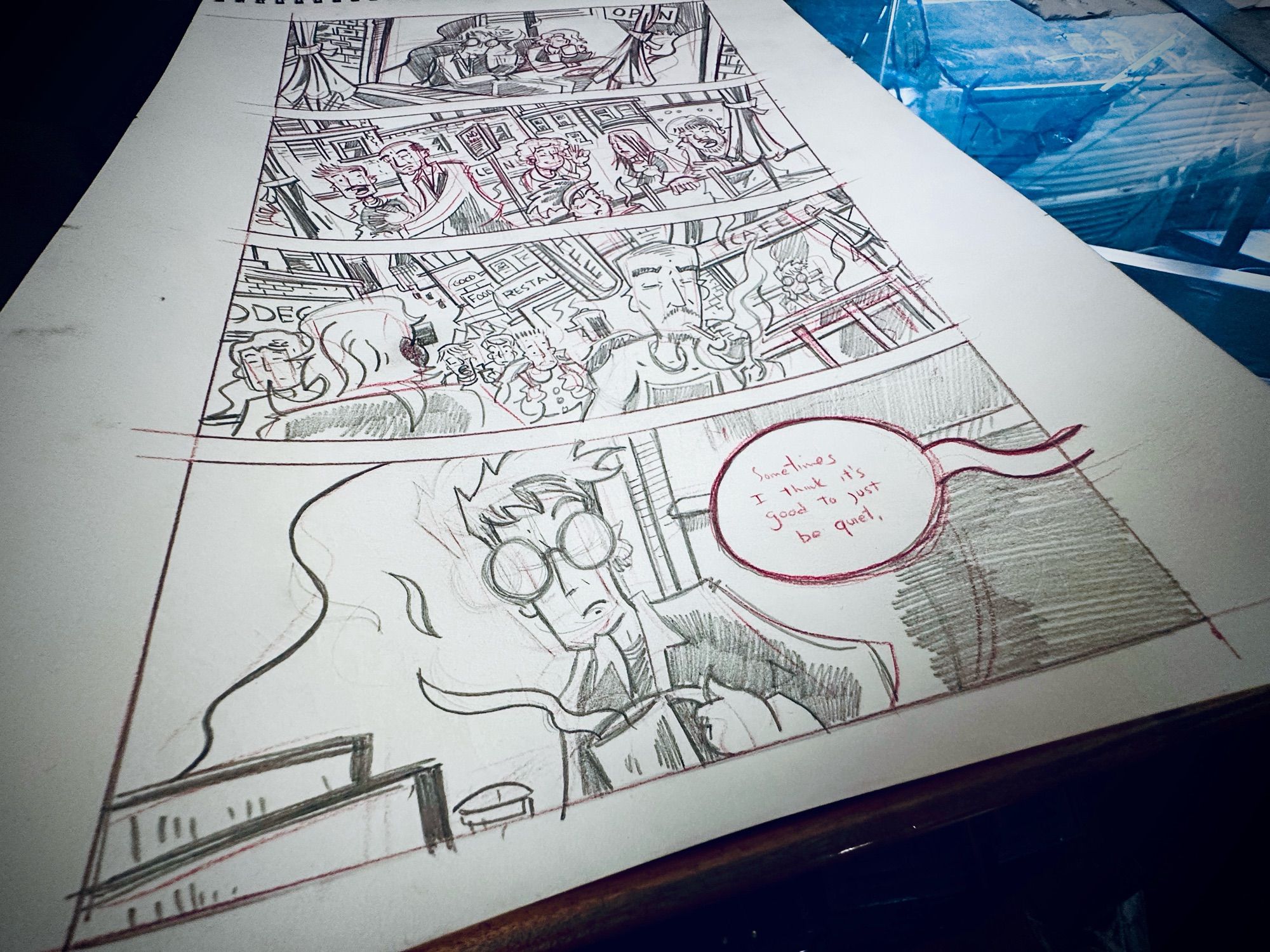 A penciled comic page sitting on a drawing board.