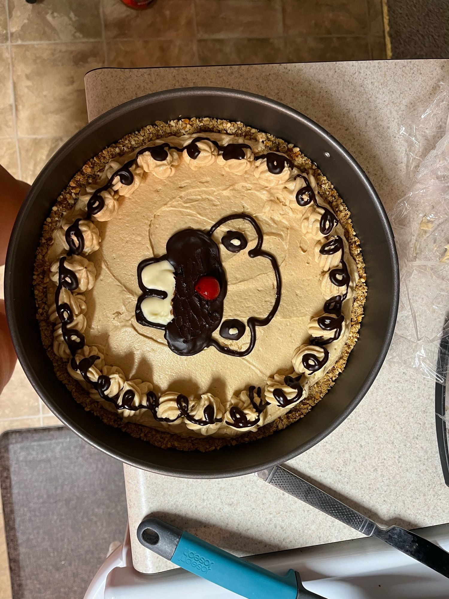 a peanut butter tart with a rough decoration of a bidoof face