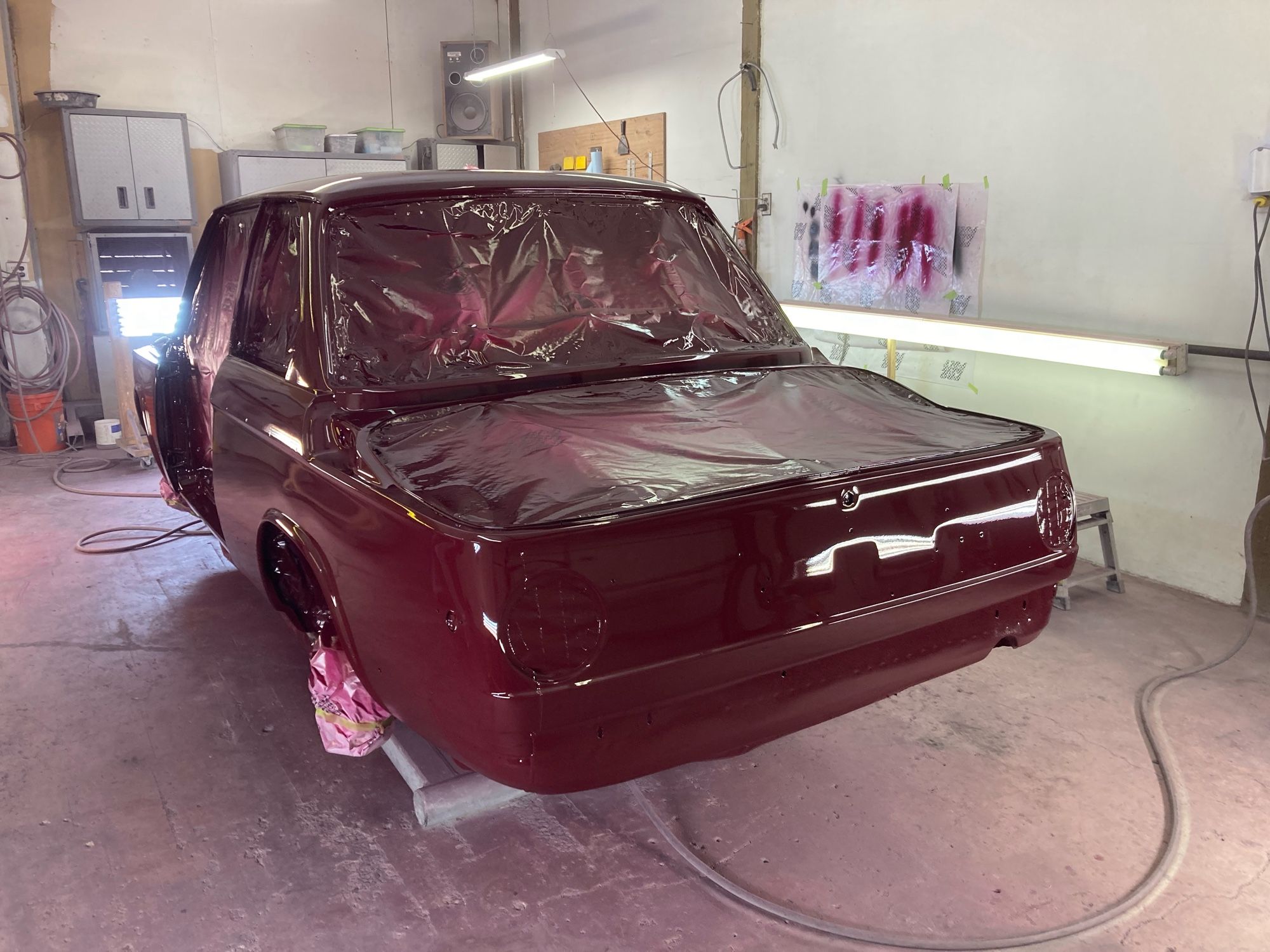 rear view of a 70s BMW being painted Malaga Red