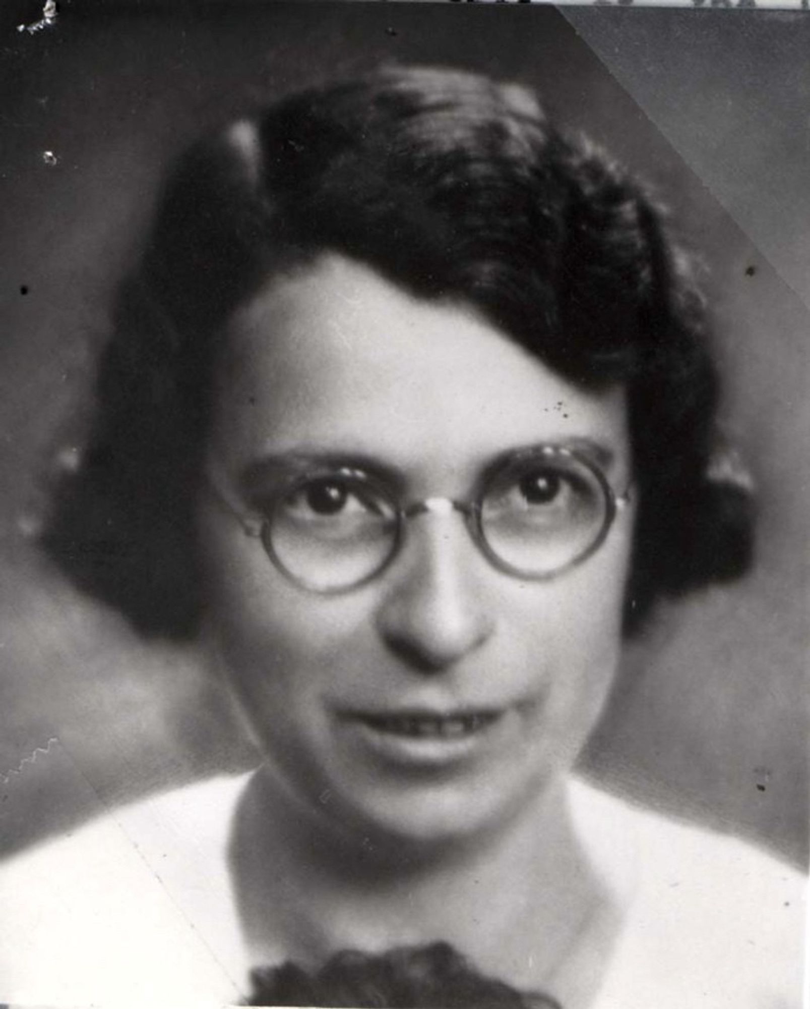 A portrait photo of a woman wearing glasses.