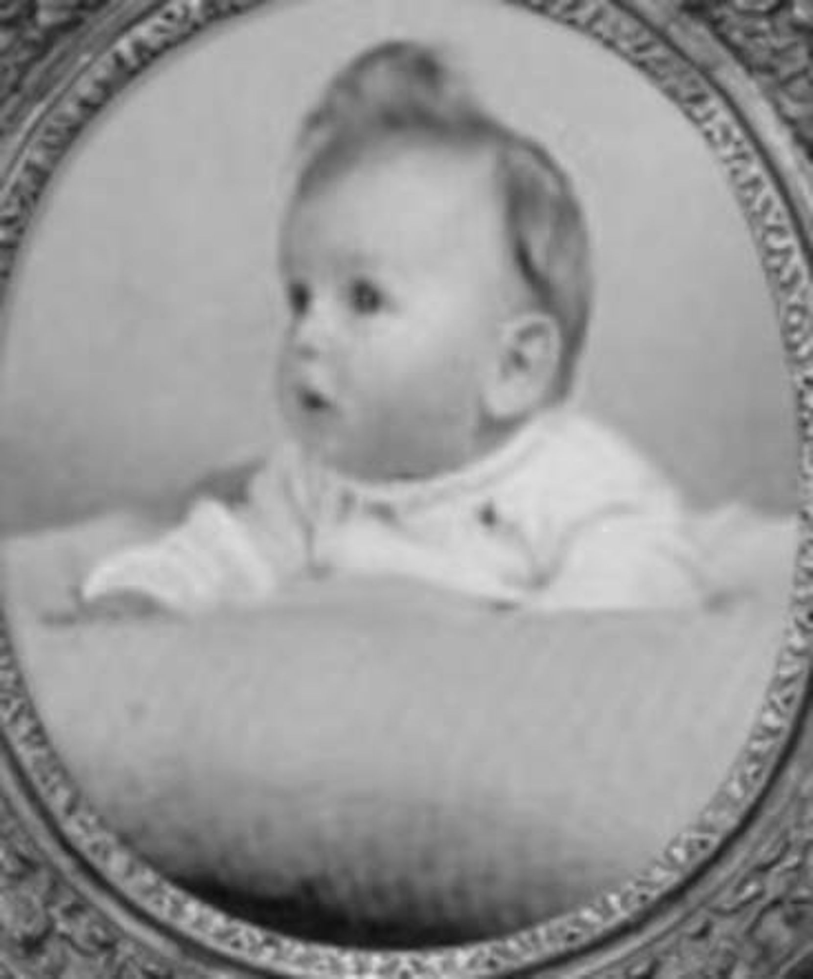 Vintage black-and-white photo of a little girl with a surprised expression, framed in an oval border.