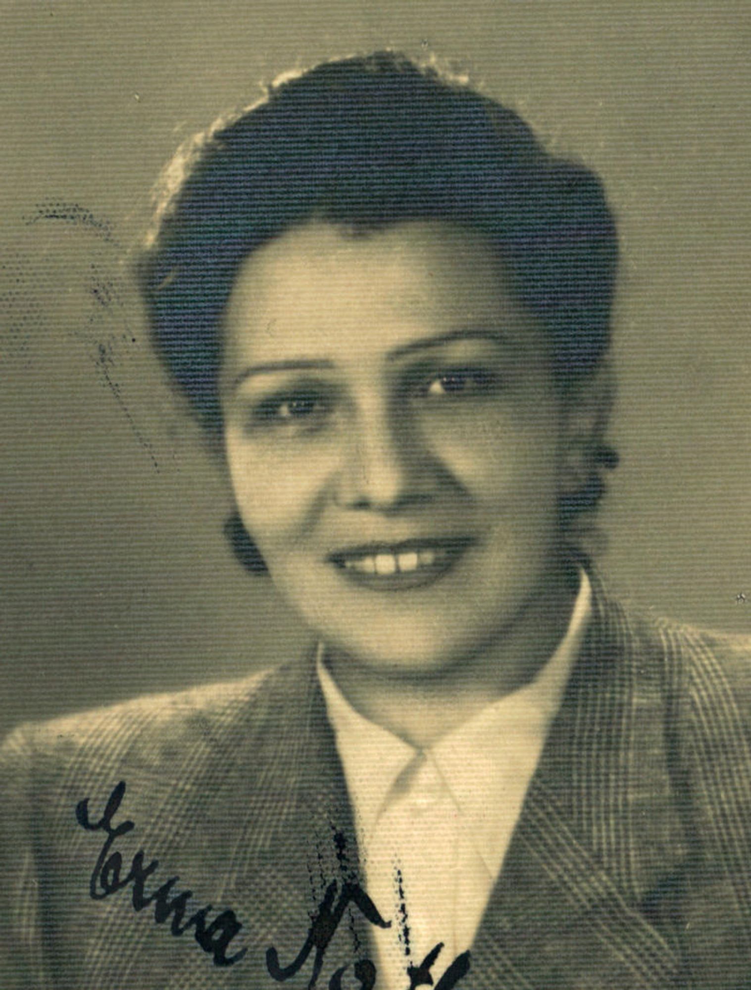 Vintage portrait of a woman wearing a checkered jacket.