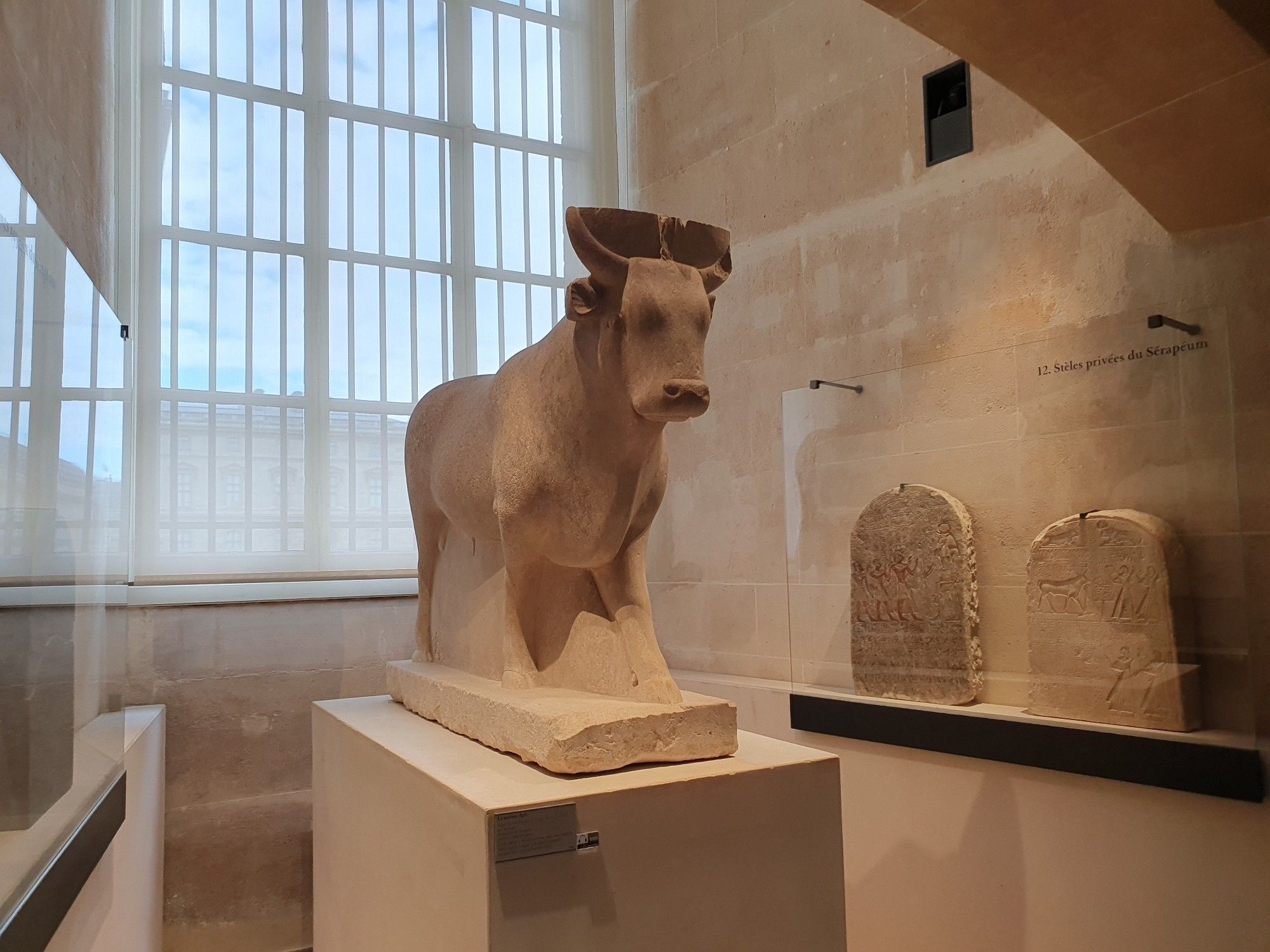 An Egyptian stone bull on a pedestal