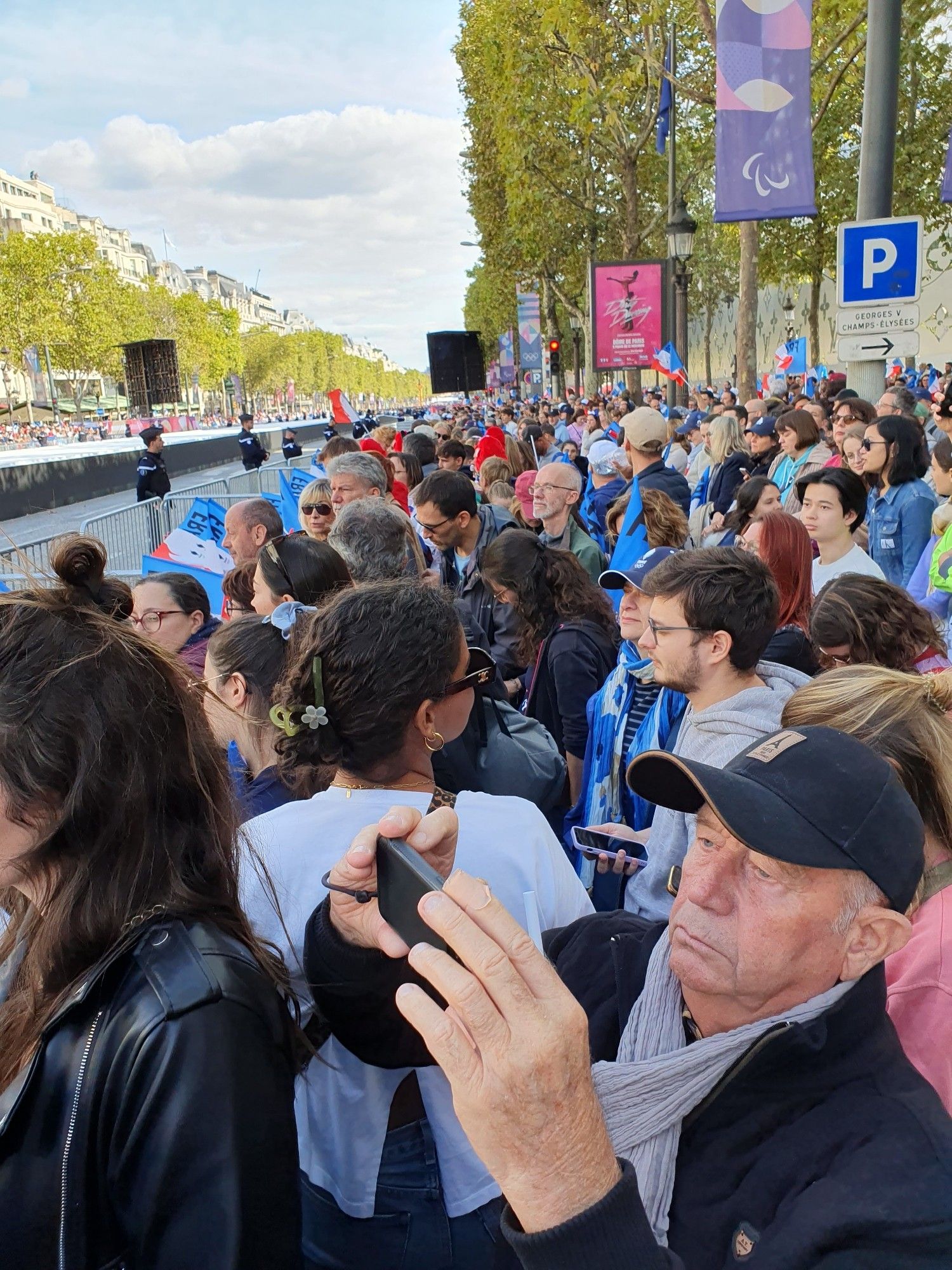 Spectators along the Champs Elysees with French flags