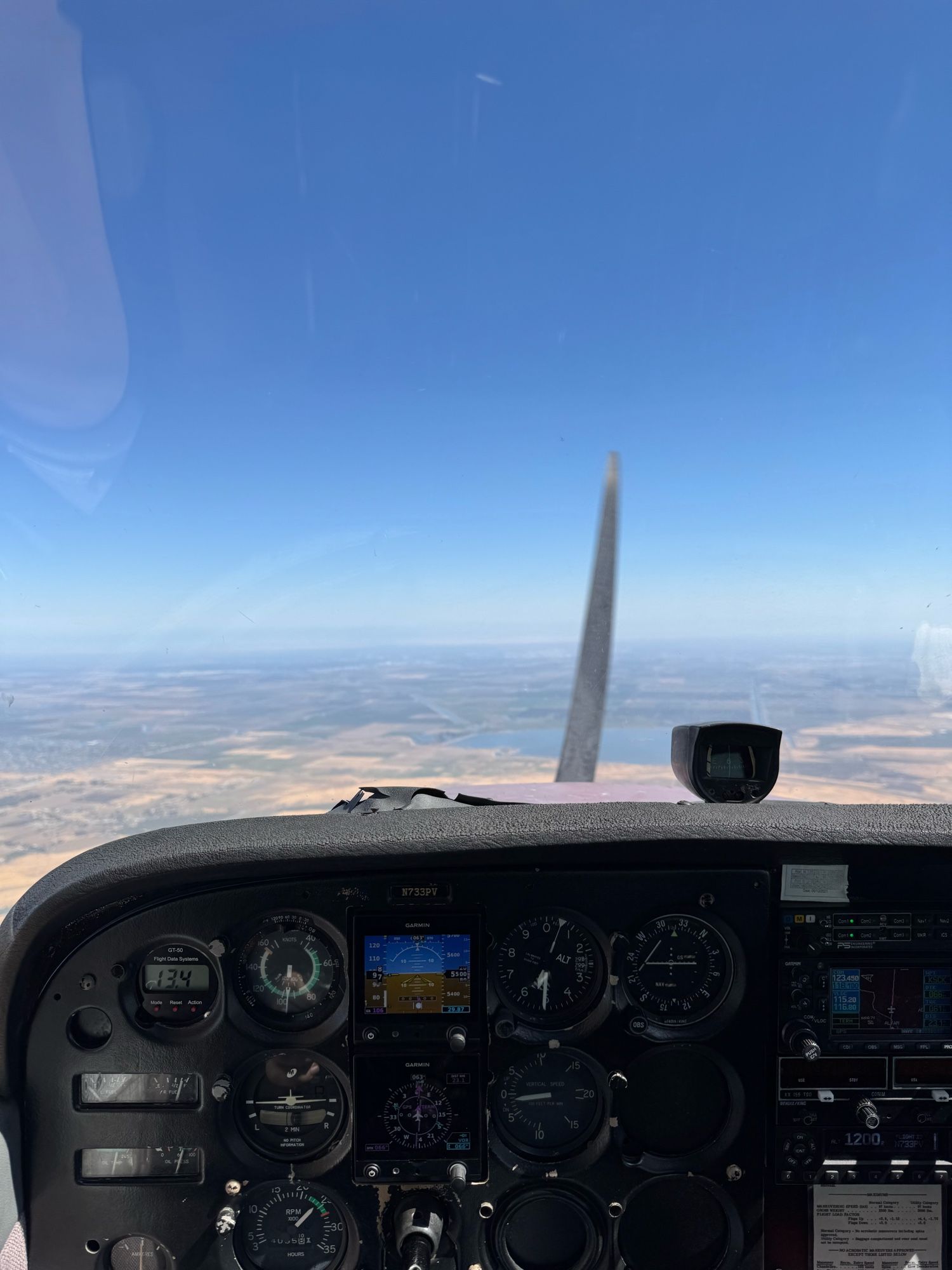 A photograph of the instrument panel of a Cessna 172N in flight, heading toward Stockton, CA and the Central Valley, east of San Francisco.