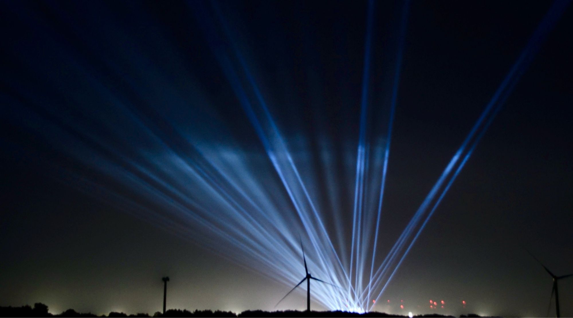 Lichtkegel des Wacken Open Air am Nachthimmel