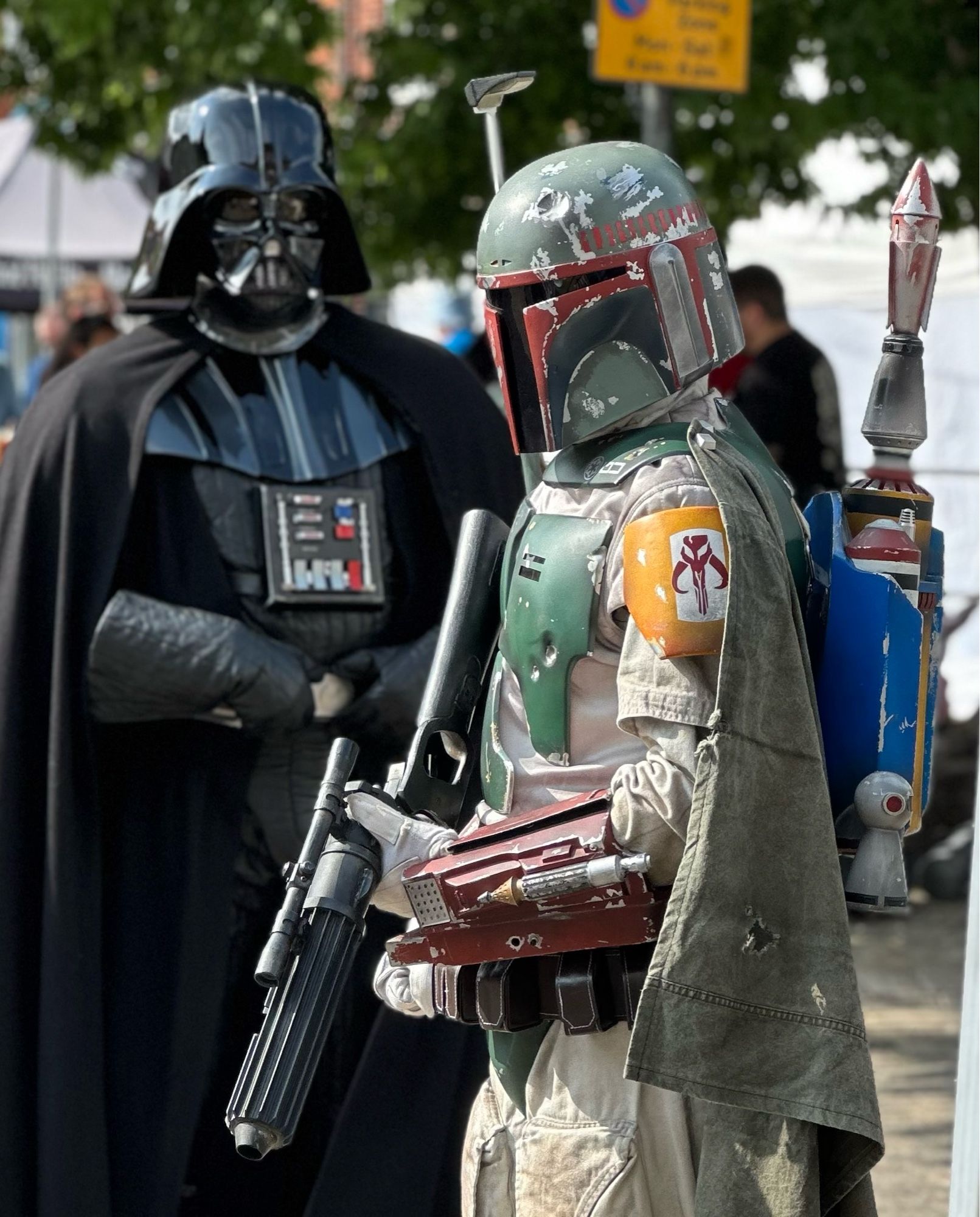 Boba Fett paces menacingly, whilst Darth Vader looms large in the background.