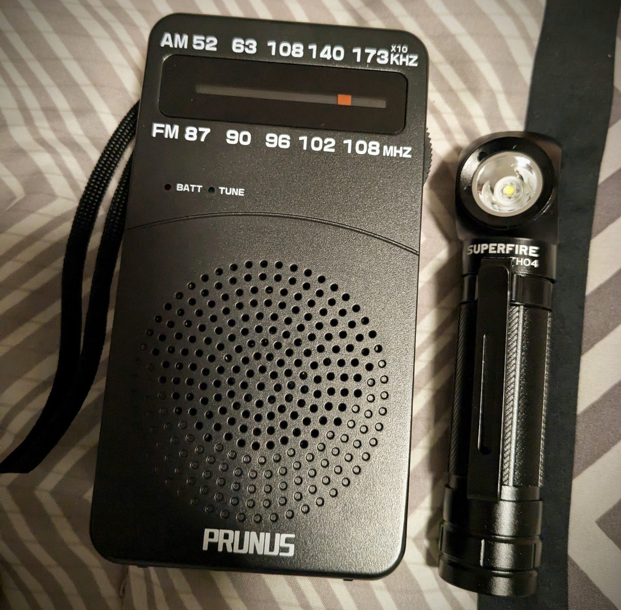 a picture of a Prunus brand handheld radio, and a right angle flashlight similar to what James Sunderland from Silent Hill 2 uses