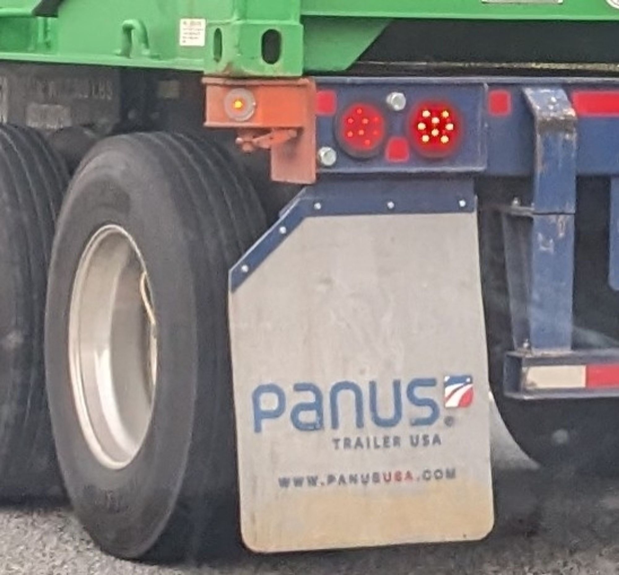 picture of a truck mudflap that says "panus", the name of the trucking company