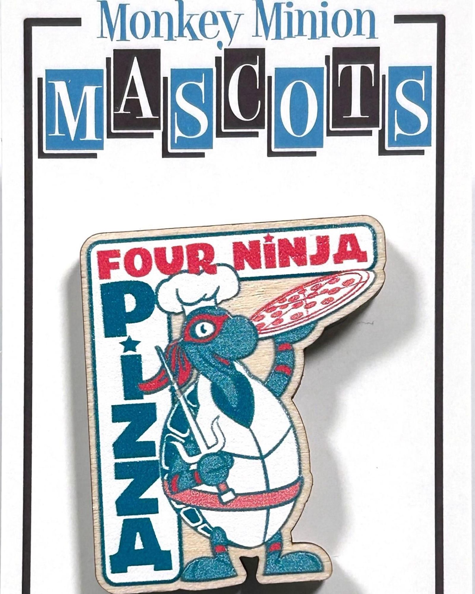 Wooden pin of a pizza-holding turtle mascot