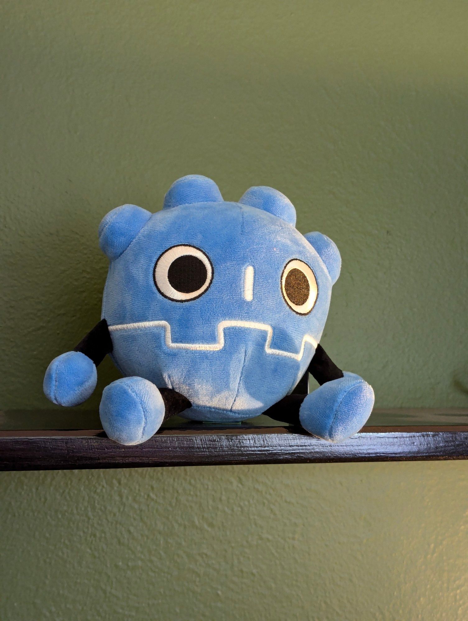 Godot plushie on a shelf