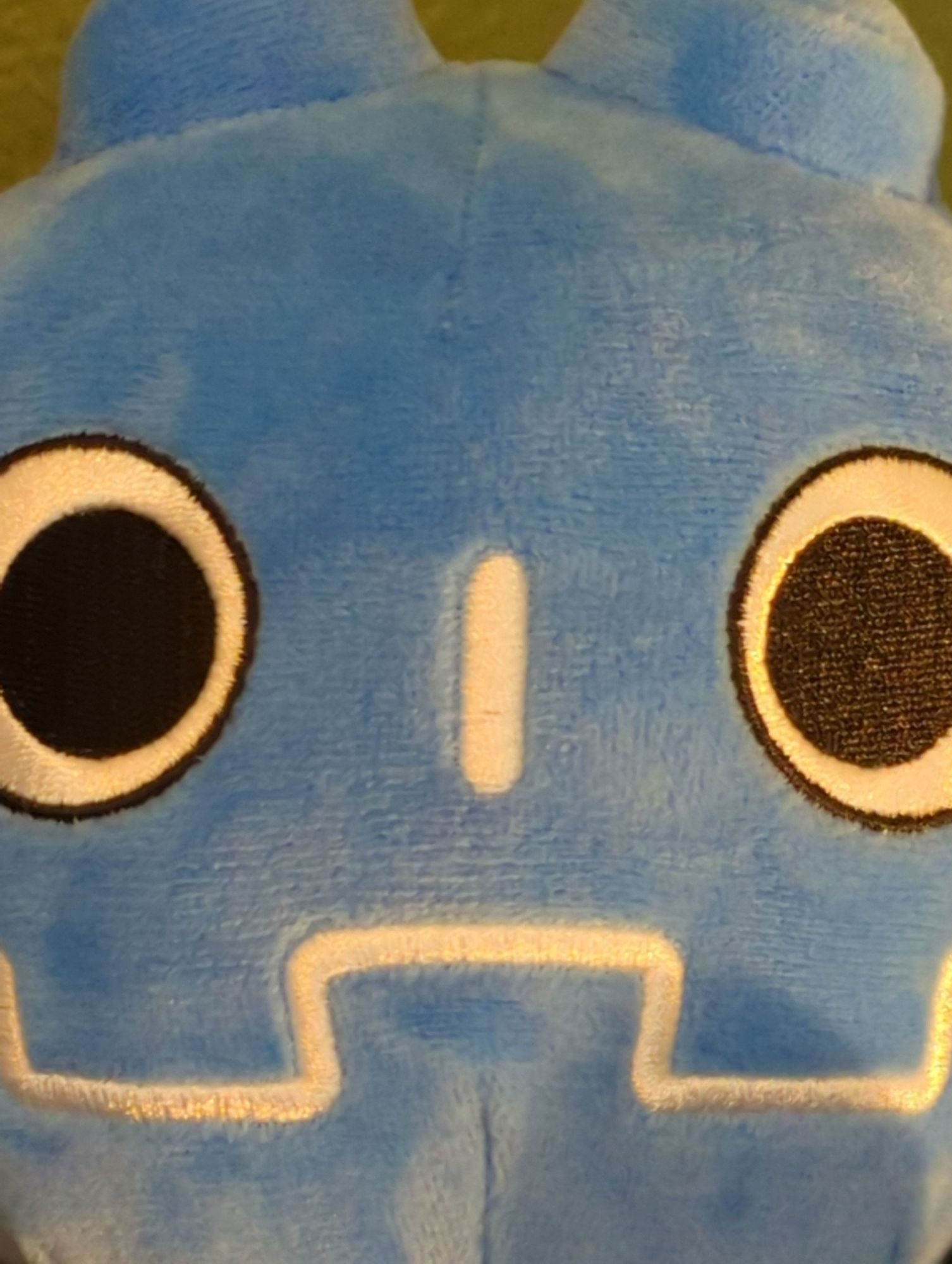 Godot plushie smiles at you