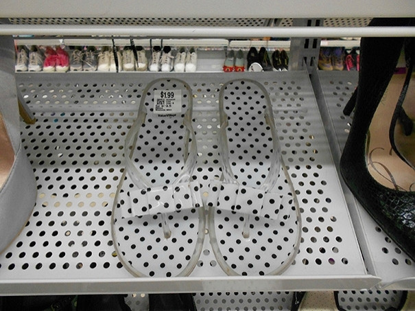 Pair of sandals on a metal thrift store shelf that has small holes closely matching the polka-dot pattern on the shoes