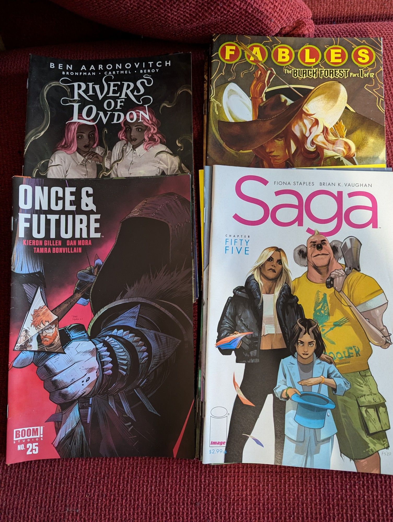 Four piles of single issues comics - Once & Future, Saga, Rivers of London and Fables.