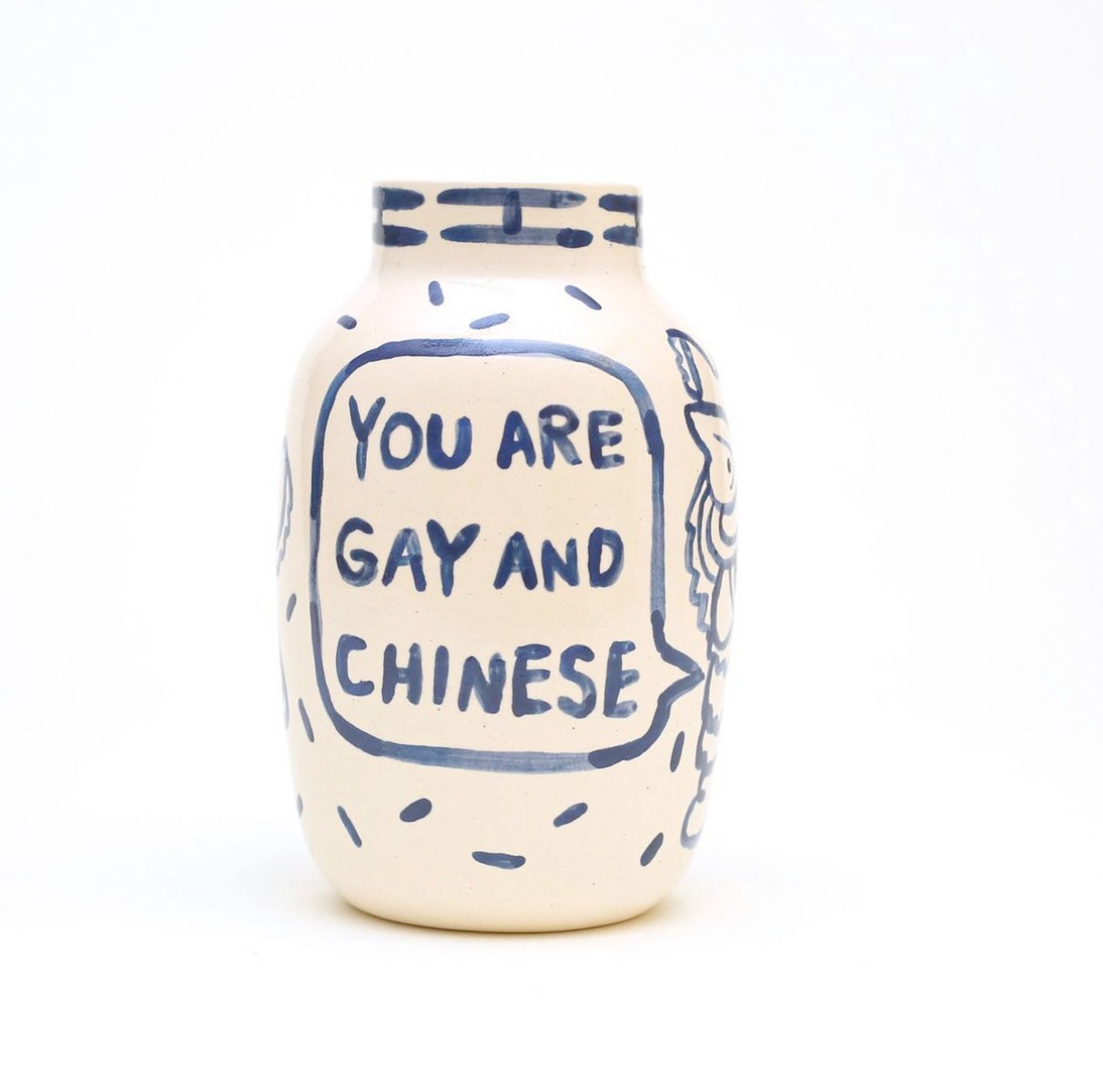 a vase with blue text written on it saying: "YOU ARE GAY AND CHINESE"