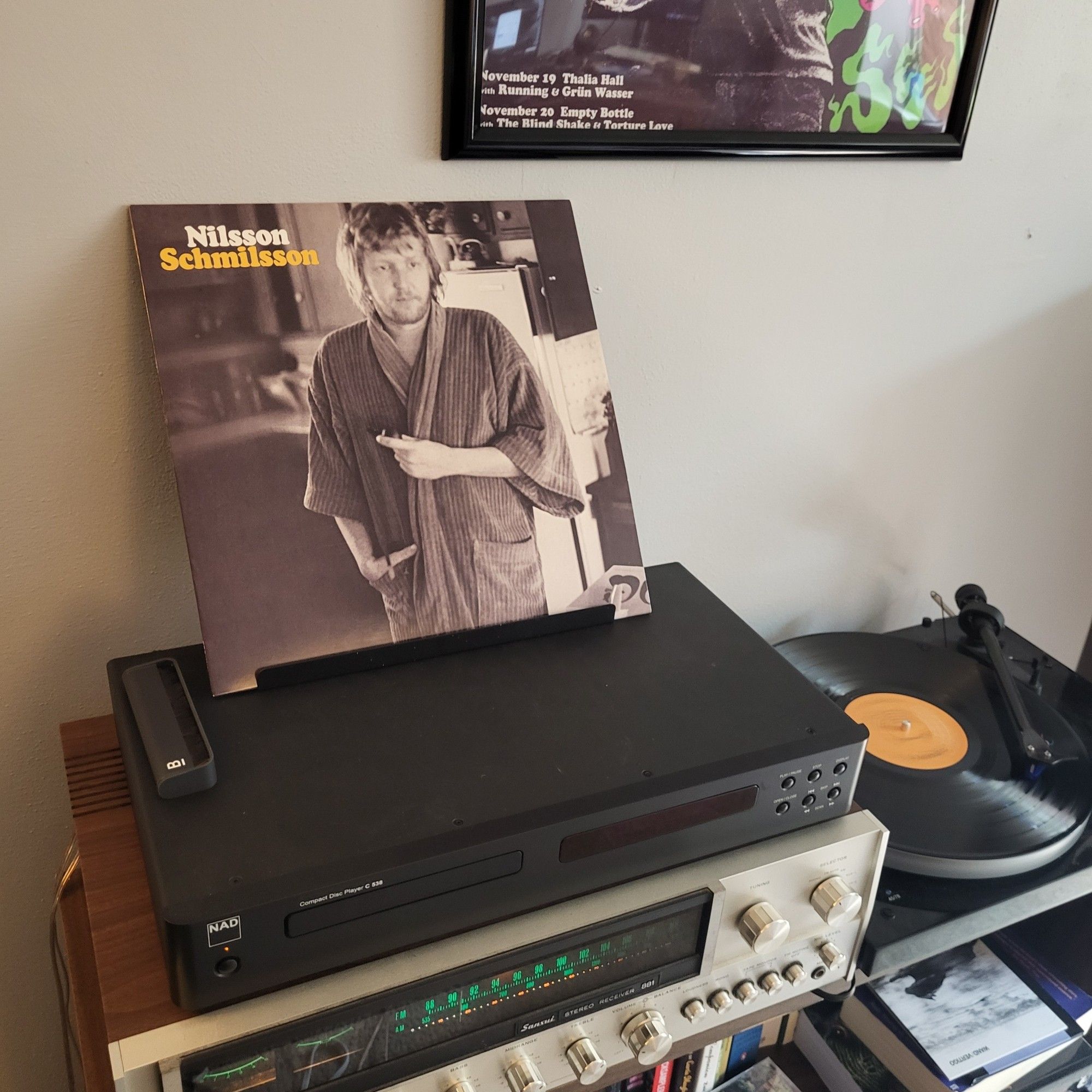 Harry Nilsson- Nilsson Schmilsson 
on a stack of stereo equipment with a black turntable spinning