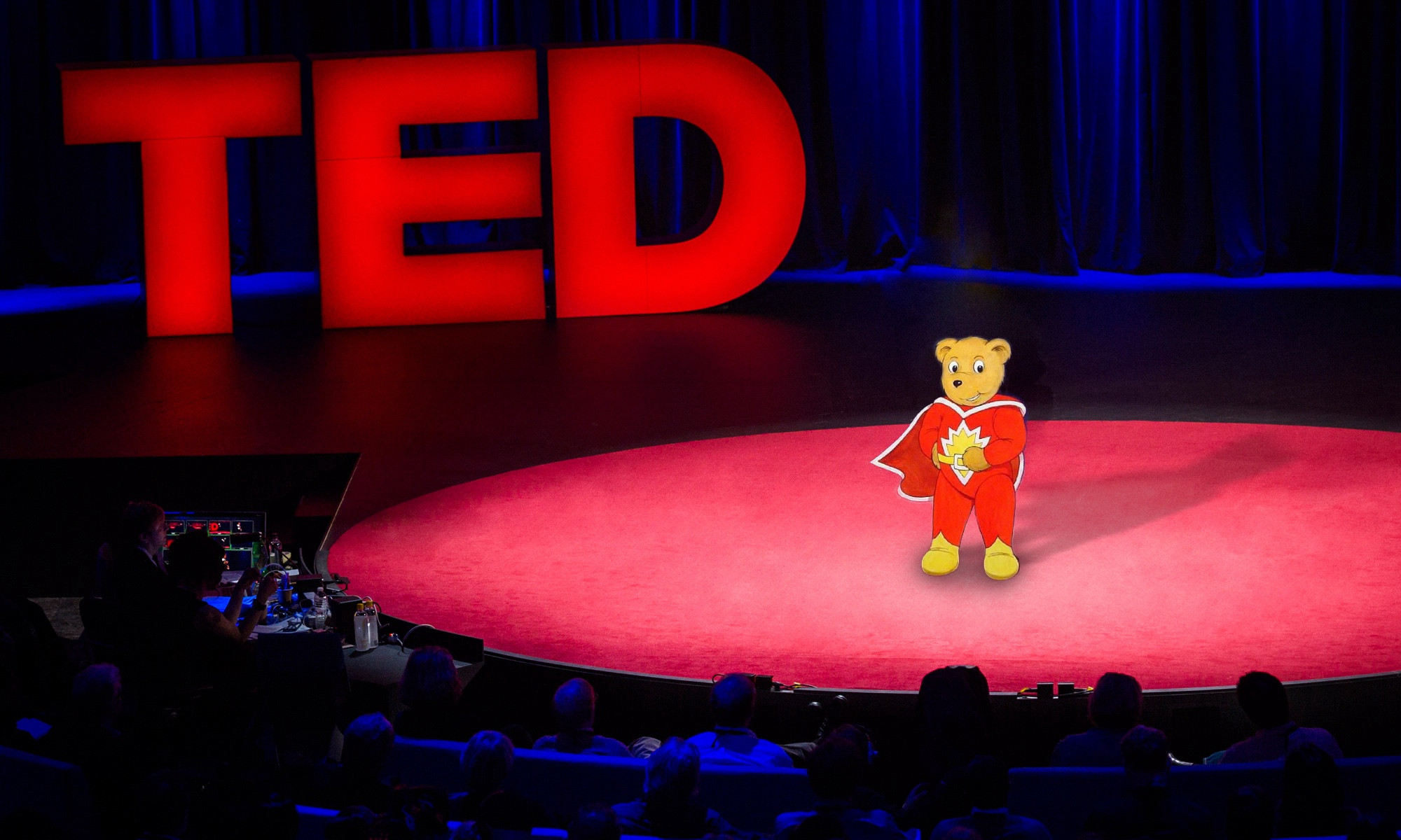 Super Ted is on stage give a TED talk to a large audience, with the big TED logo behind him. Composited badly on my phone